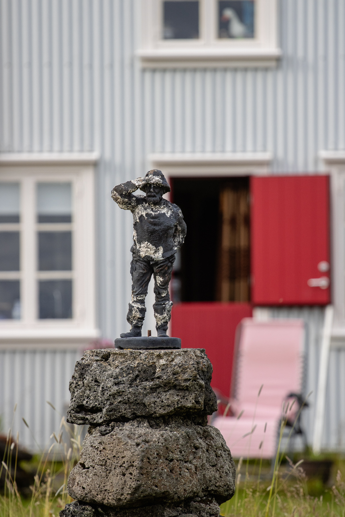 A small statue in a private garden.