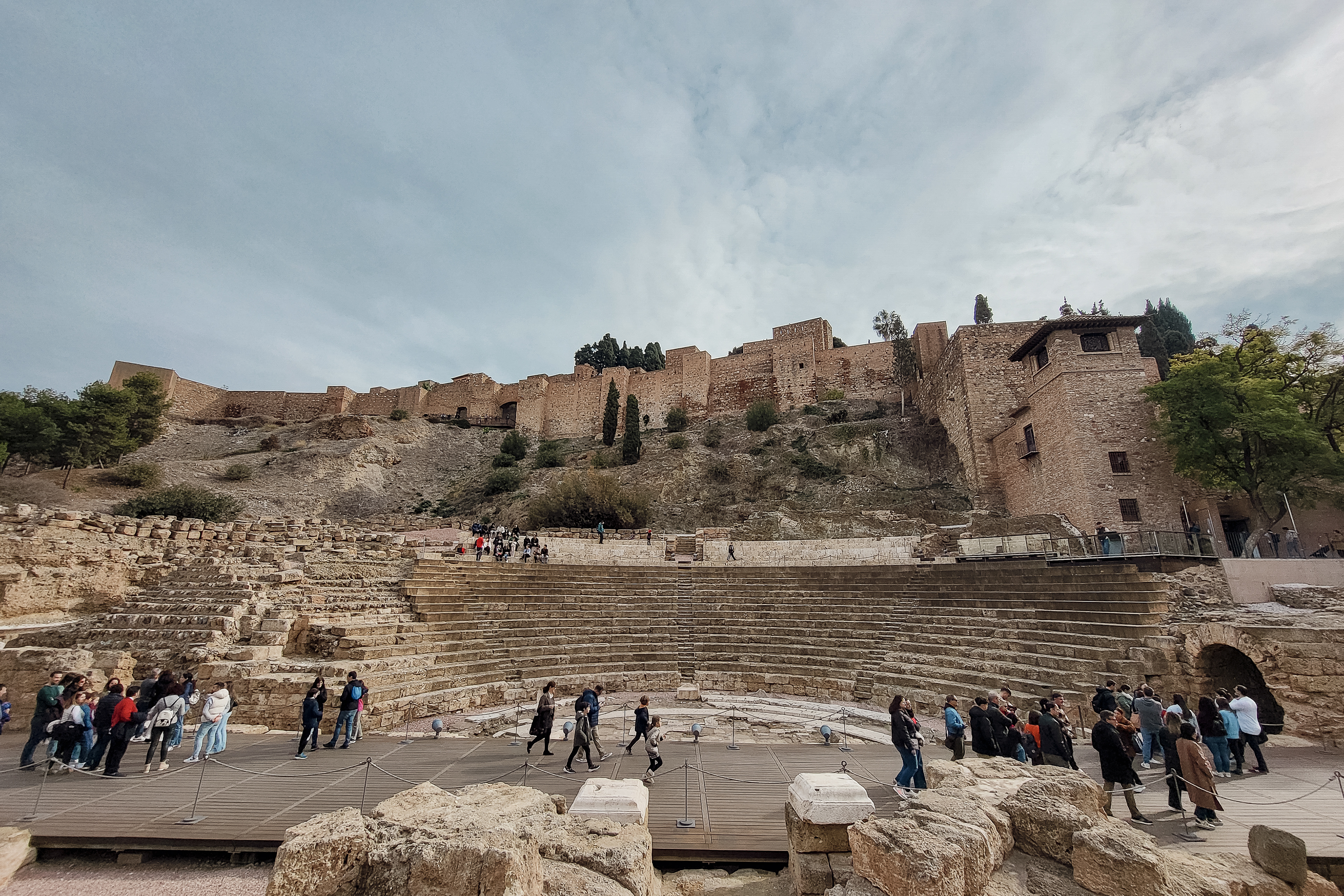 The Roman amphitheatre of Malaga, with the Moor fortress towering behind it.