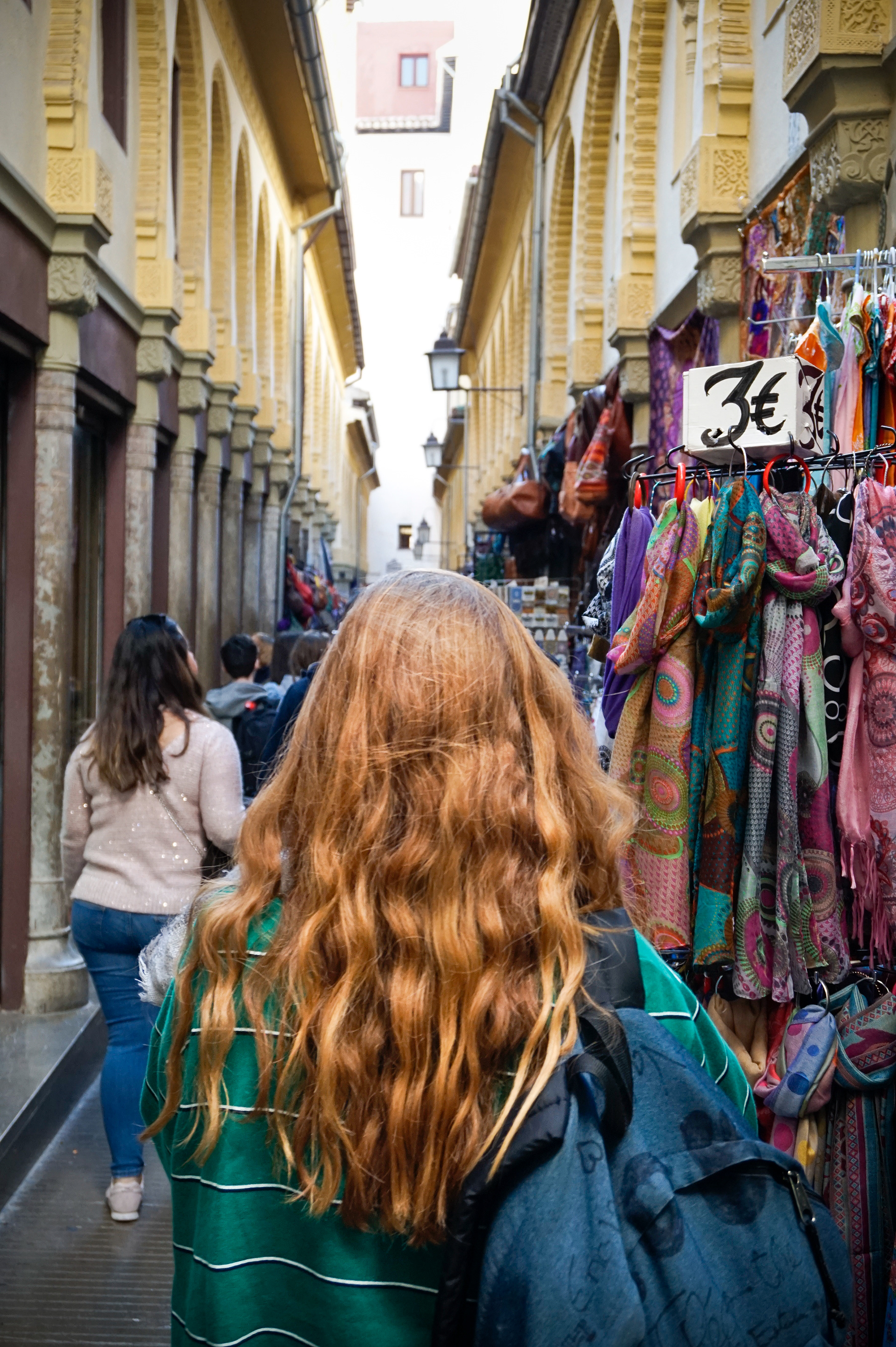 Also from February 2018, a lady with beautiful long red hair shopping in the small streets of the "new town".