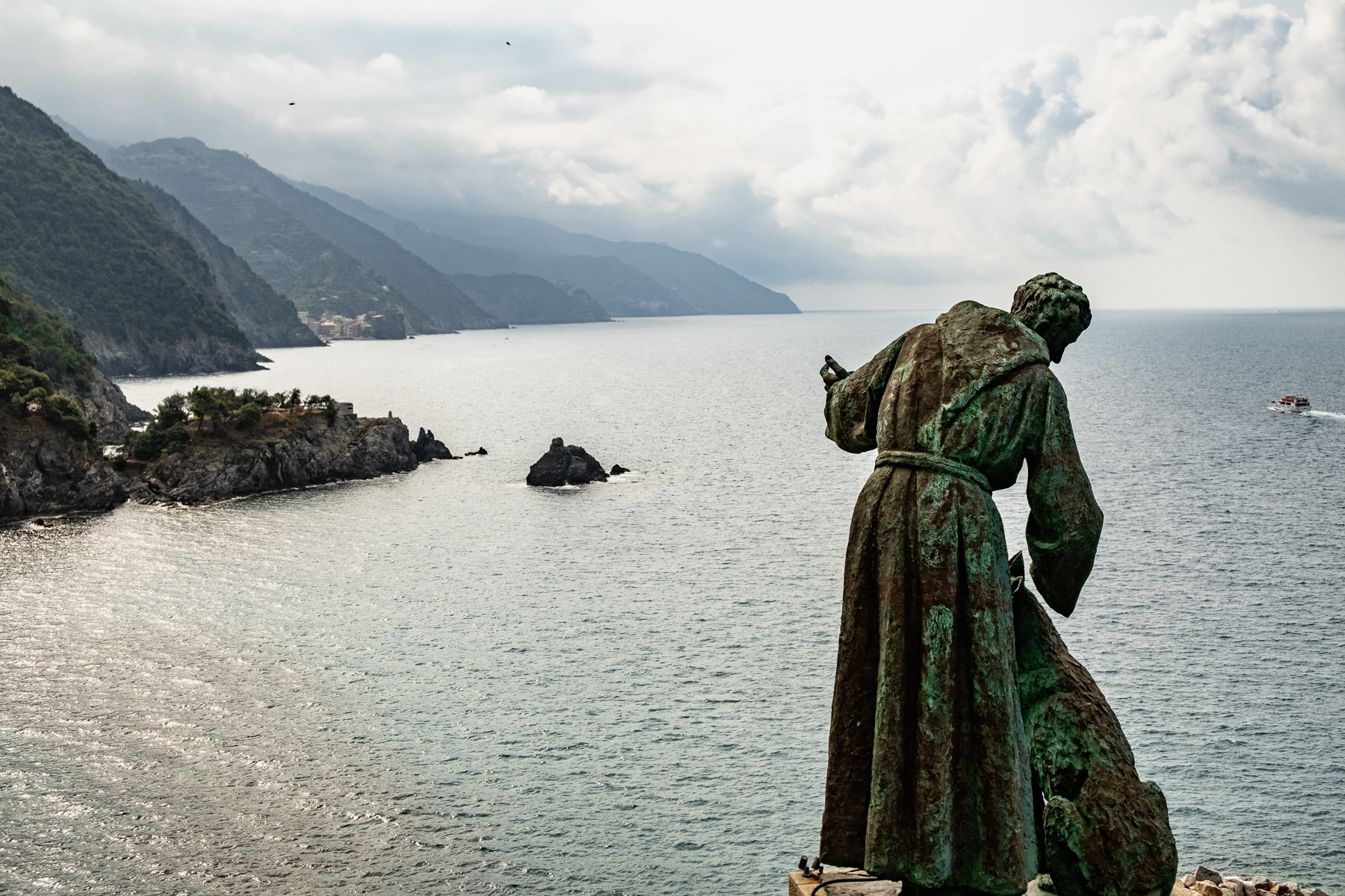 Statue of San Francesco d'Assisi, and dog, looking out over the Ligurian coastline.