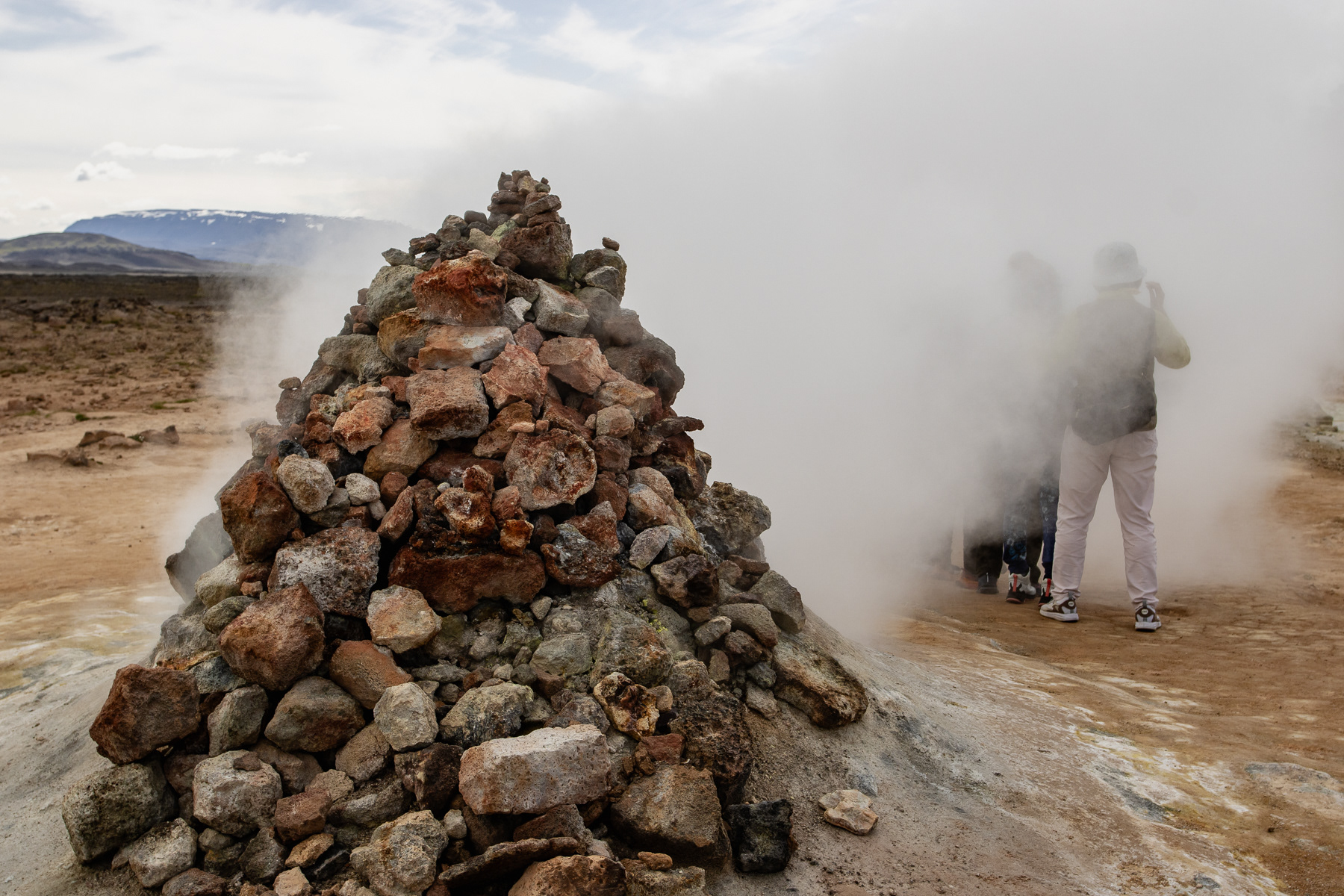 All health issues ignored, these tourists dive into the geothermal smoke for a photo opp.