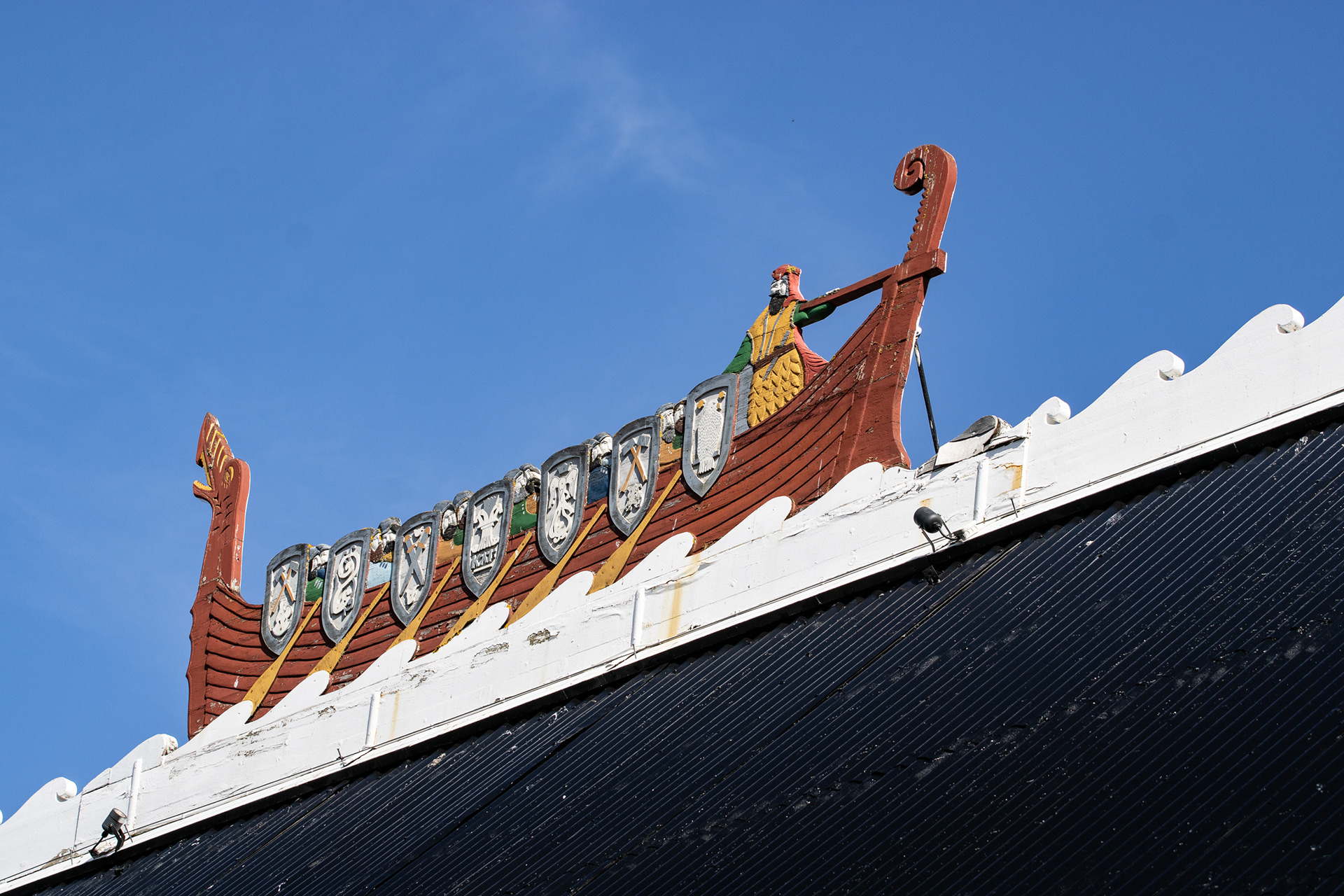 A flat viking boat on top of a restaurant, Reykjavik.