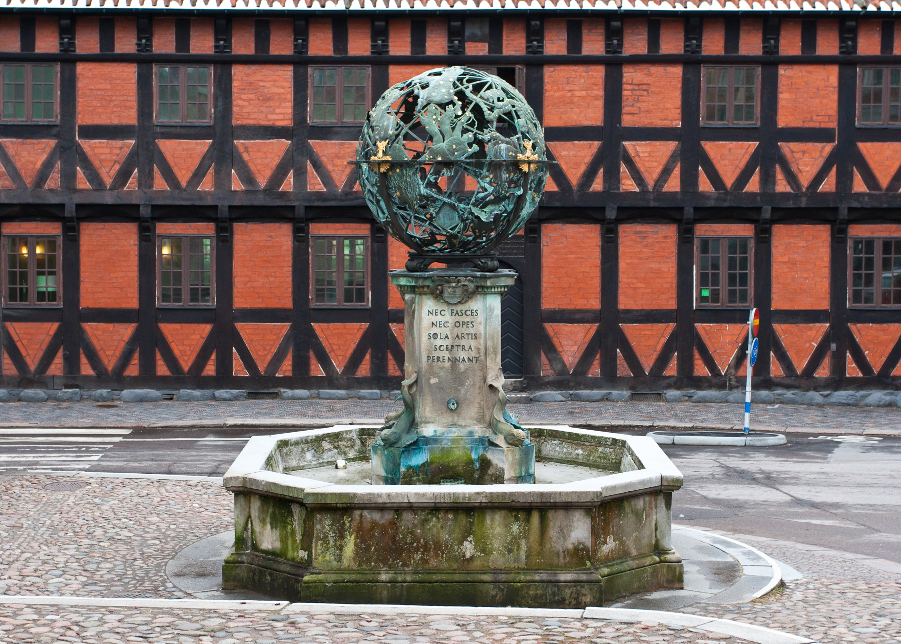 Tyho Brahe Fountain and a half-timbered house in the centre of Helsingborg.