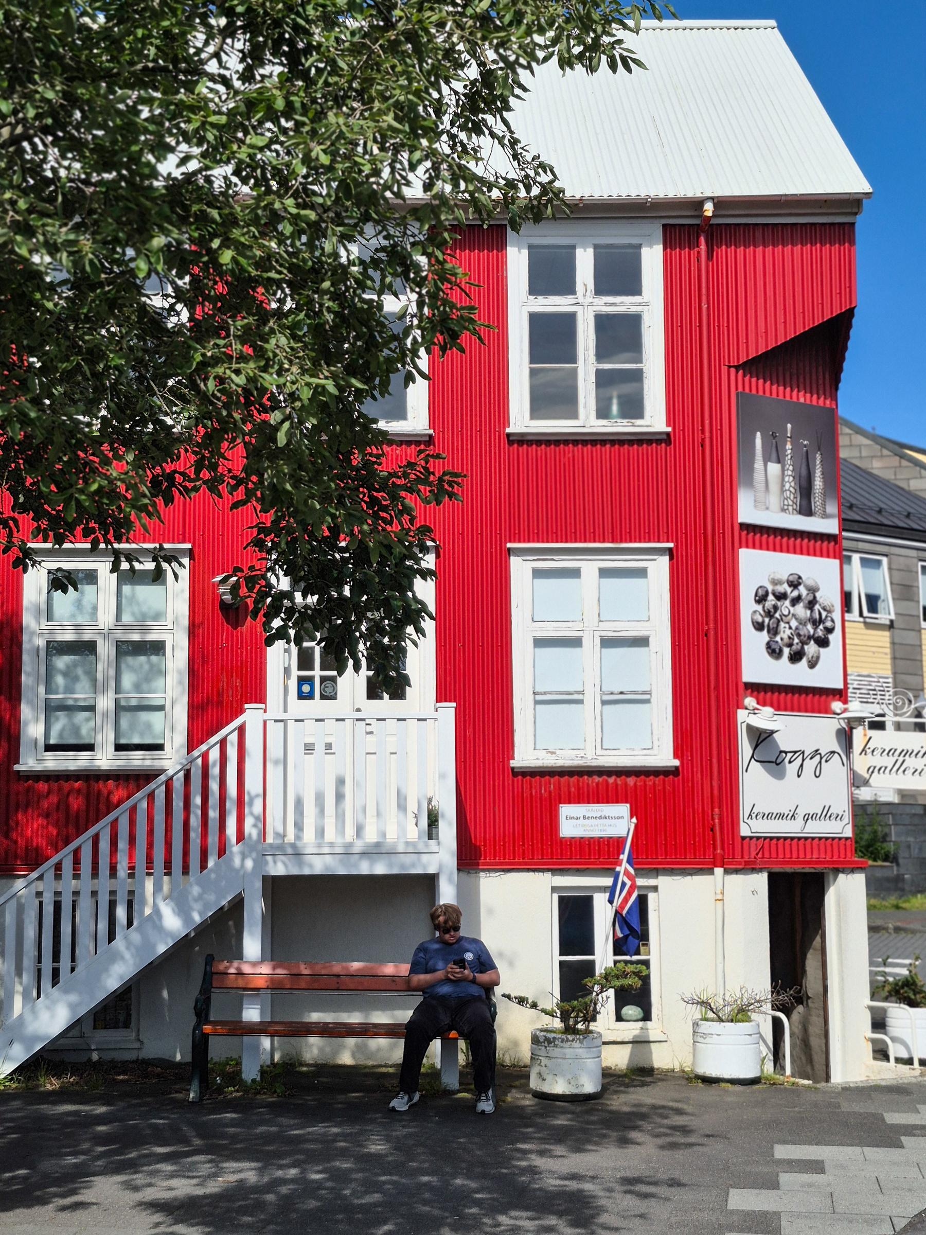 A red house and shop in the city centre.