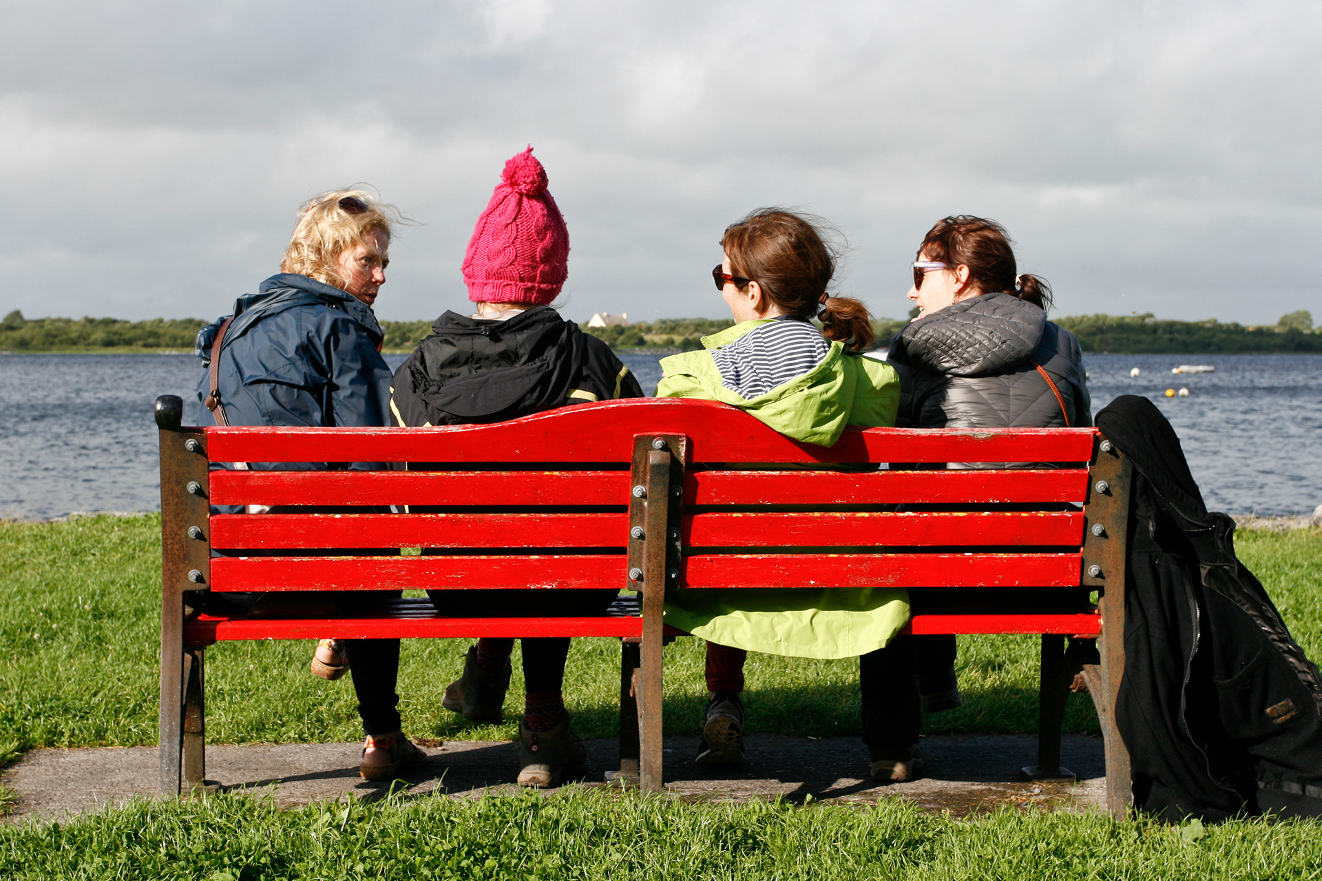 Four ladies on a red bench in Kinvarra, Ireland