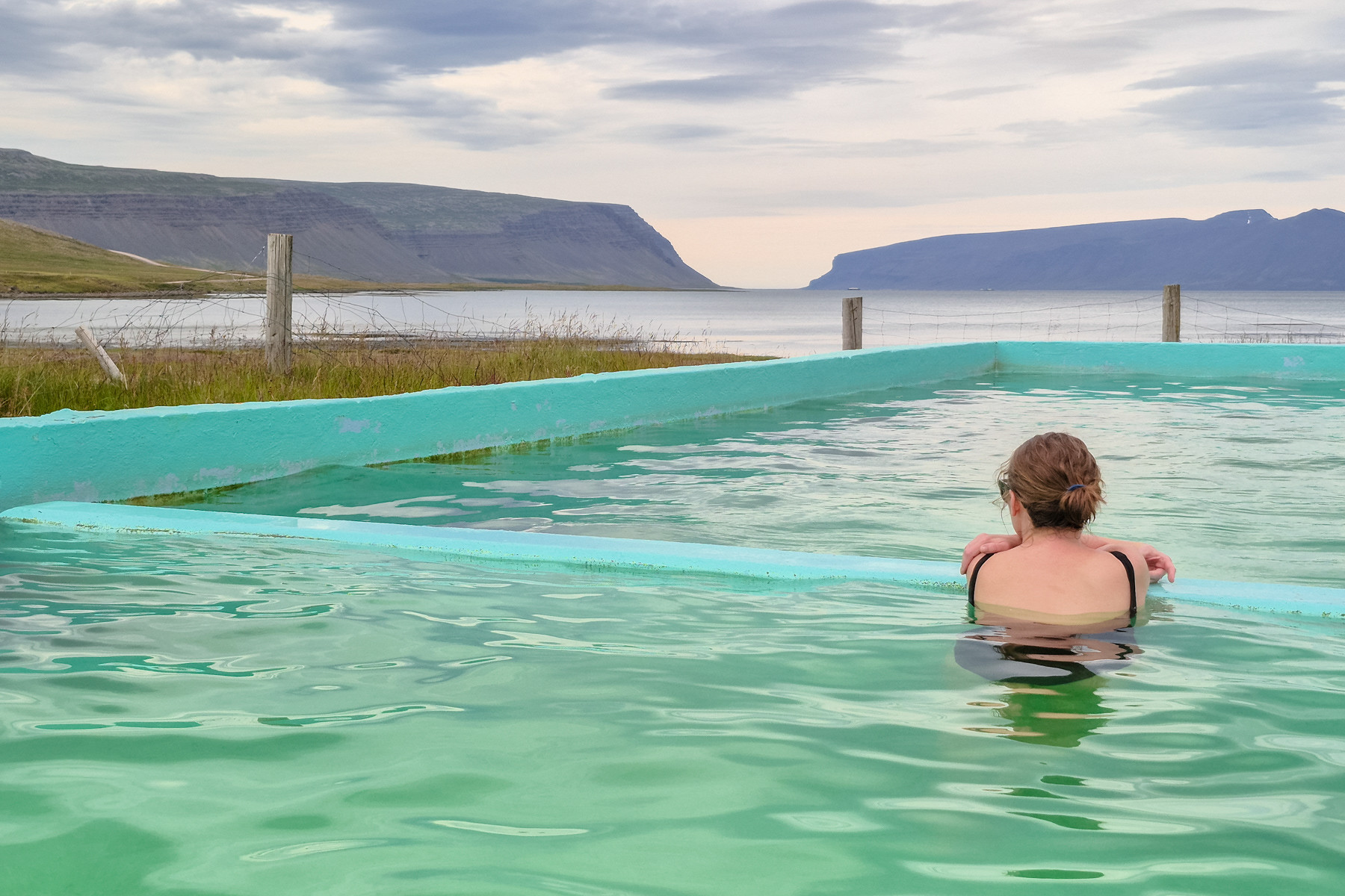 A geothermal pool looking out over Patreksfjörður fjord.