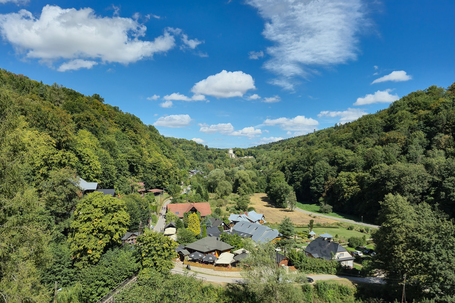 View on the settlement of houses, places to stay and restaurants at the foot of Ojców Castle., August 2025.