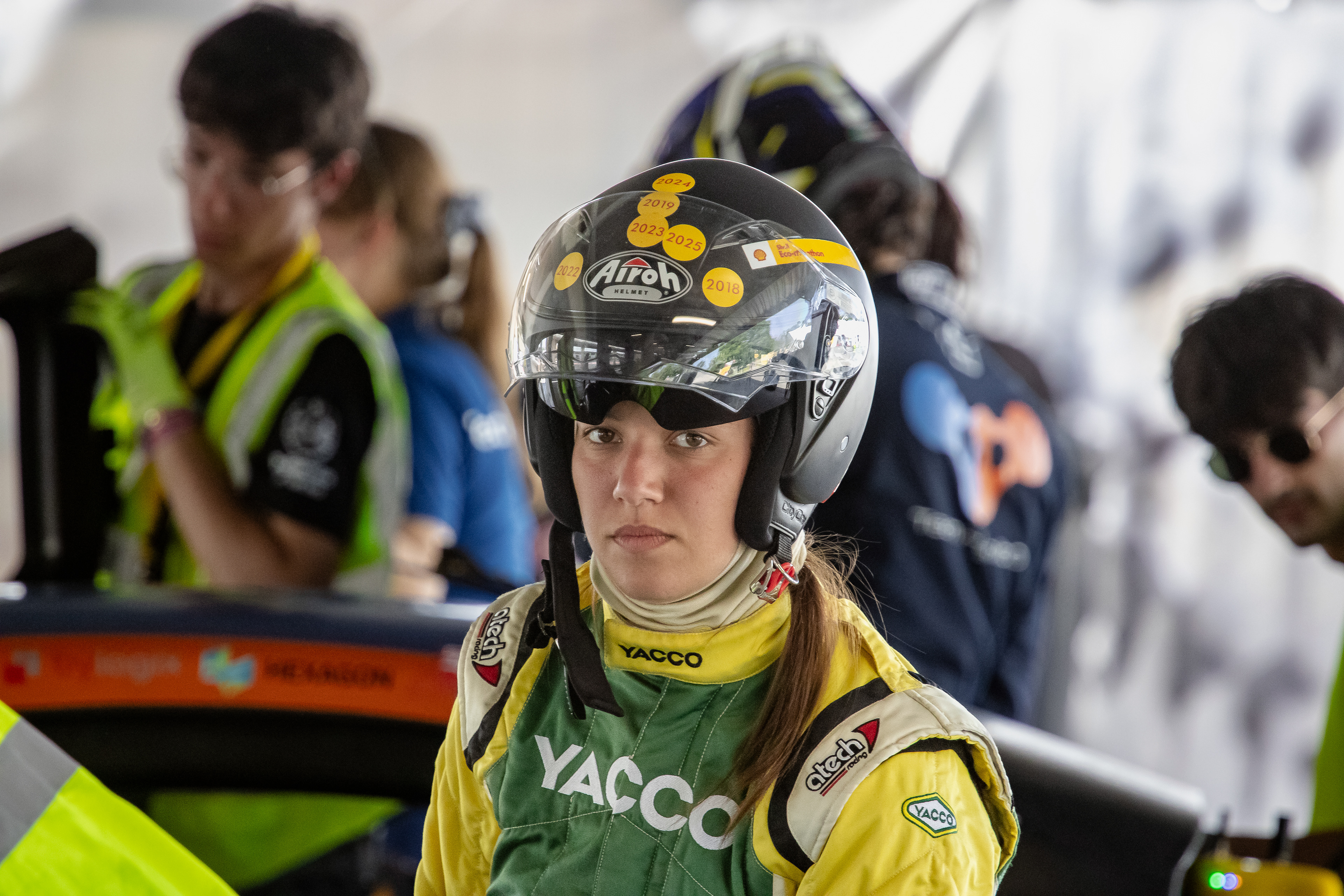 A young female driver before entering her urban concept vehicle at pre-race final checks.