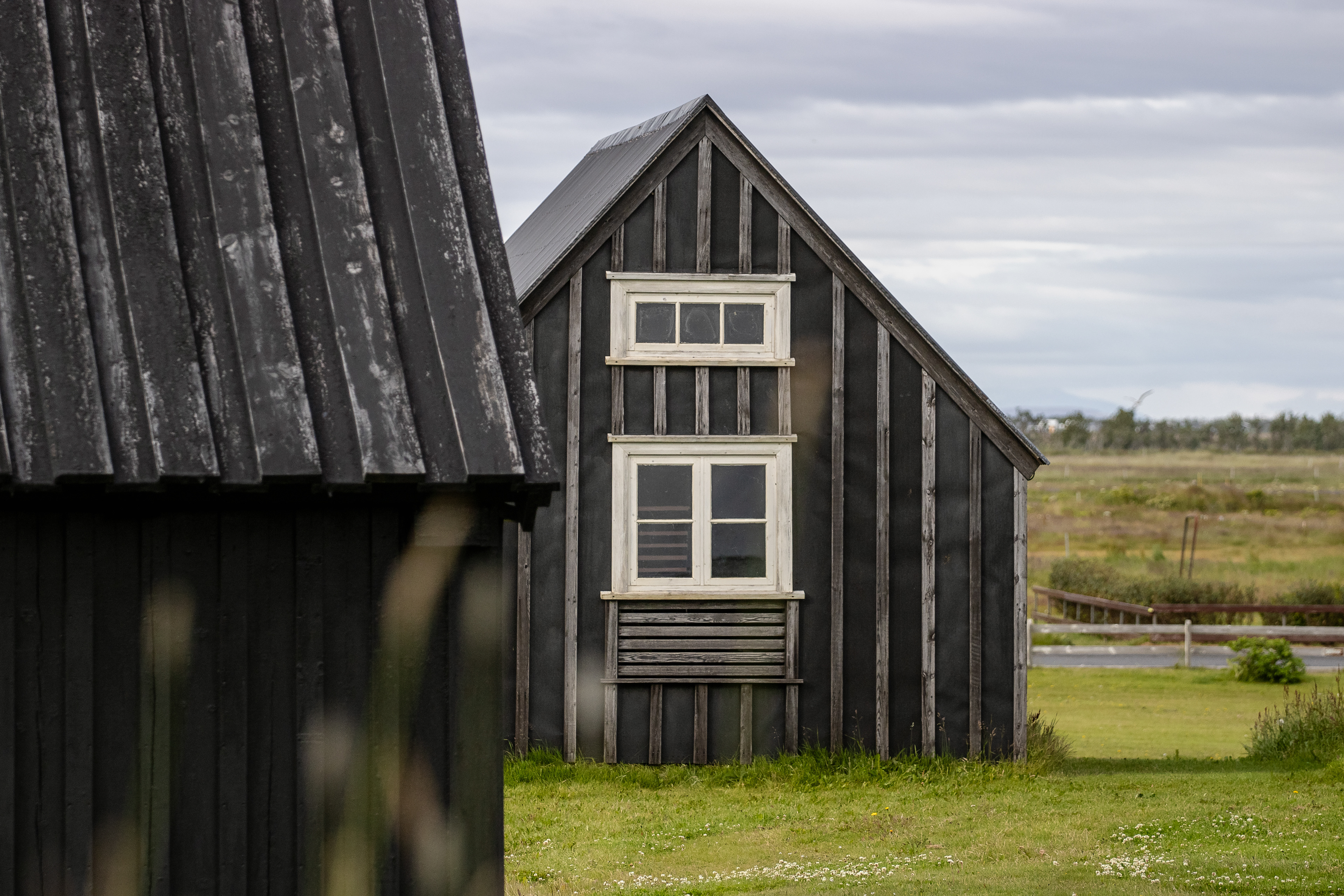 A historic Norwegian wooden cabin, now part of the Árnesinga Folk Museum.