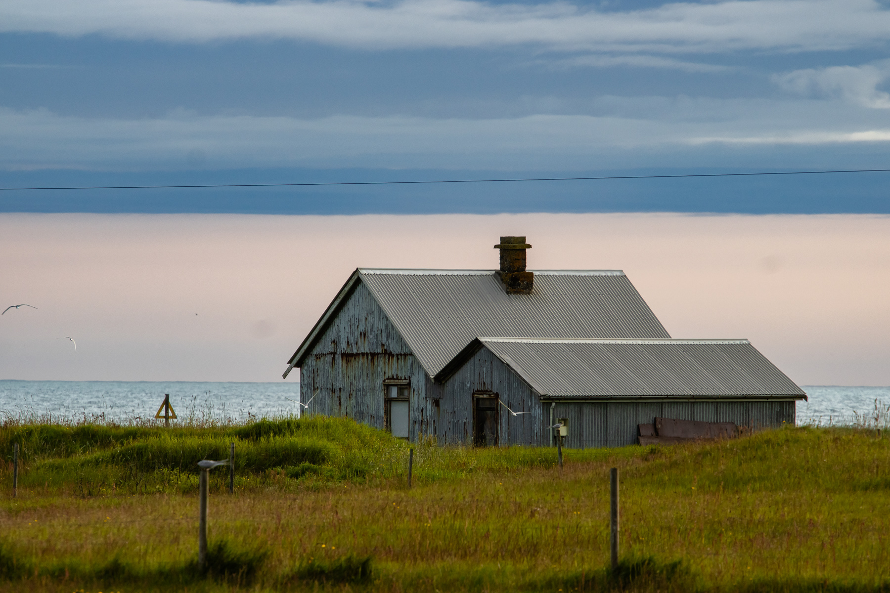 A weathered beach home in Southwestern The rocky coast of Southwestern Suðurland.