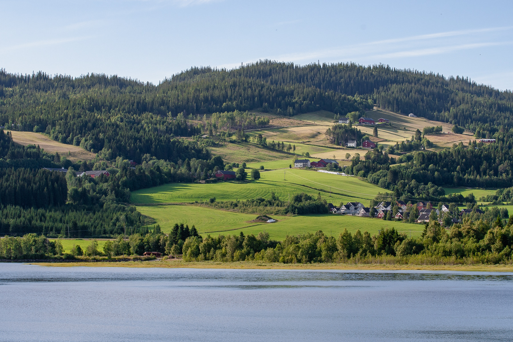 A small settlement on a low hill at a lake.