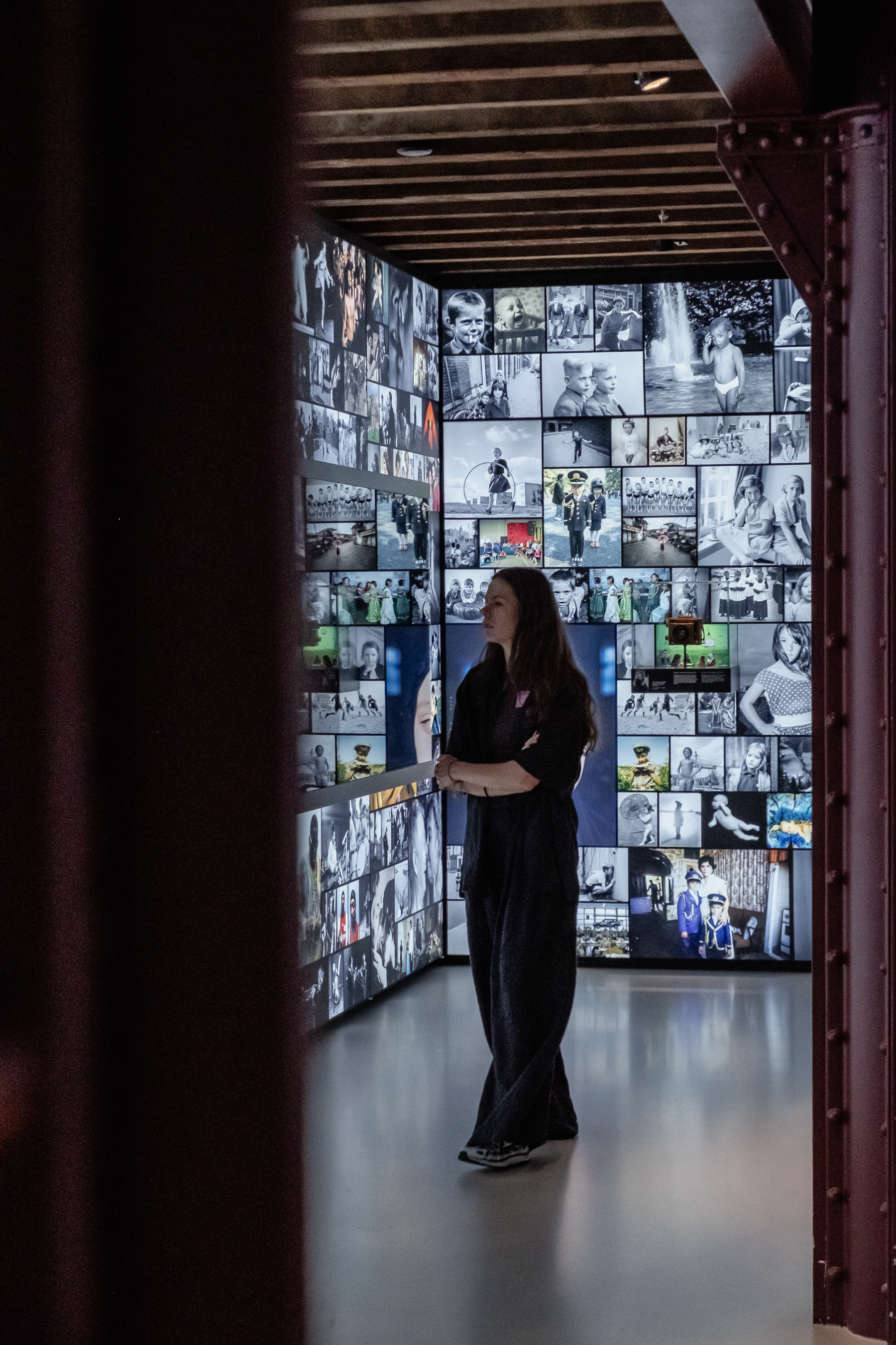 A female visitor taking in the wall of historic photography.