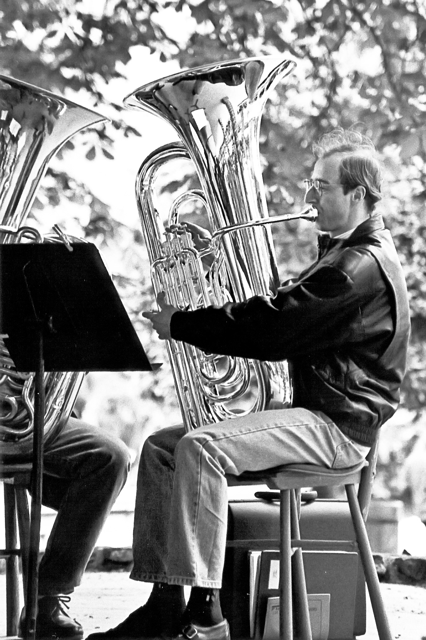 A tuba player somwhere in the centre of the city.