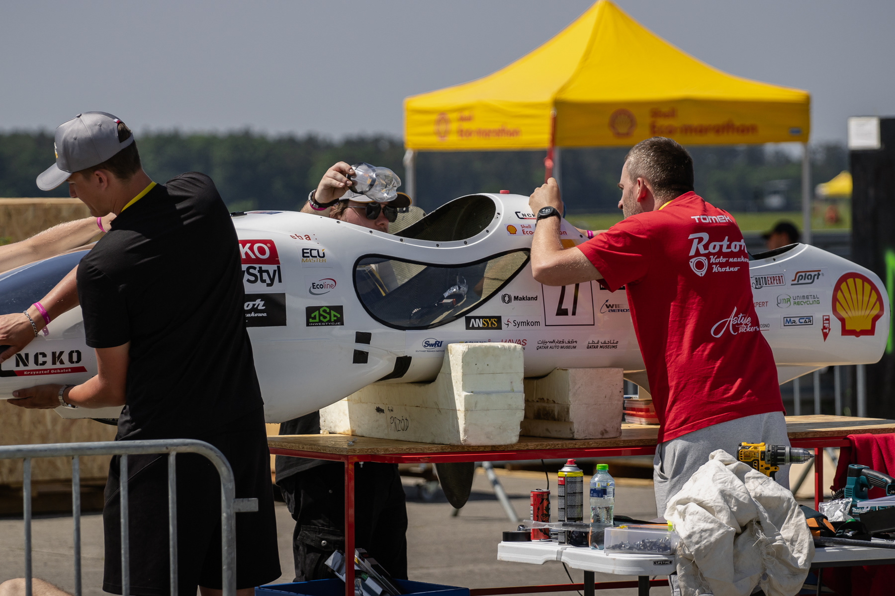 Adjustment to a prototype, outside the paddock and outside the pit.
