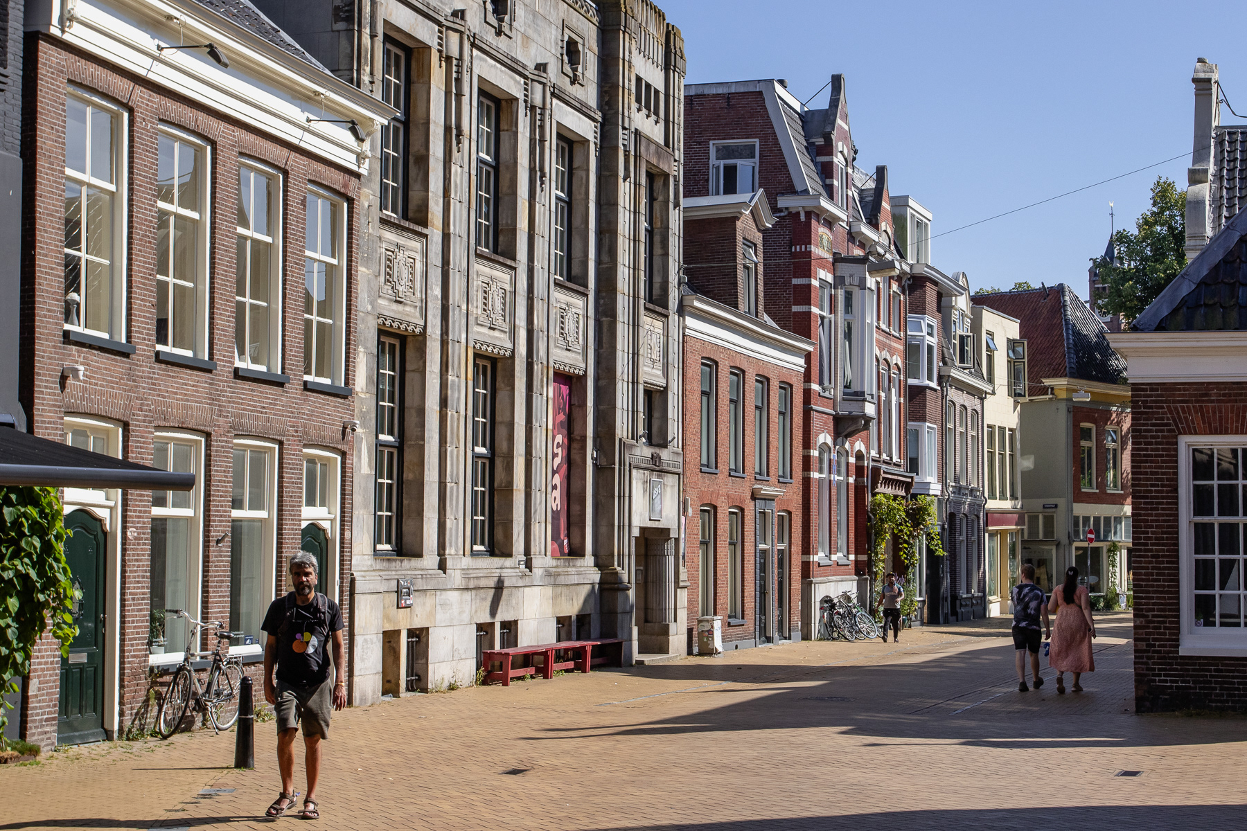 The inner city of Groningen on a sunny August day, with pedestrians taking a stroll.