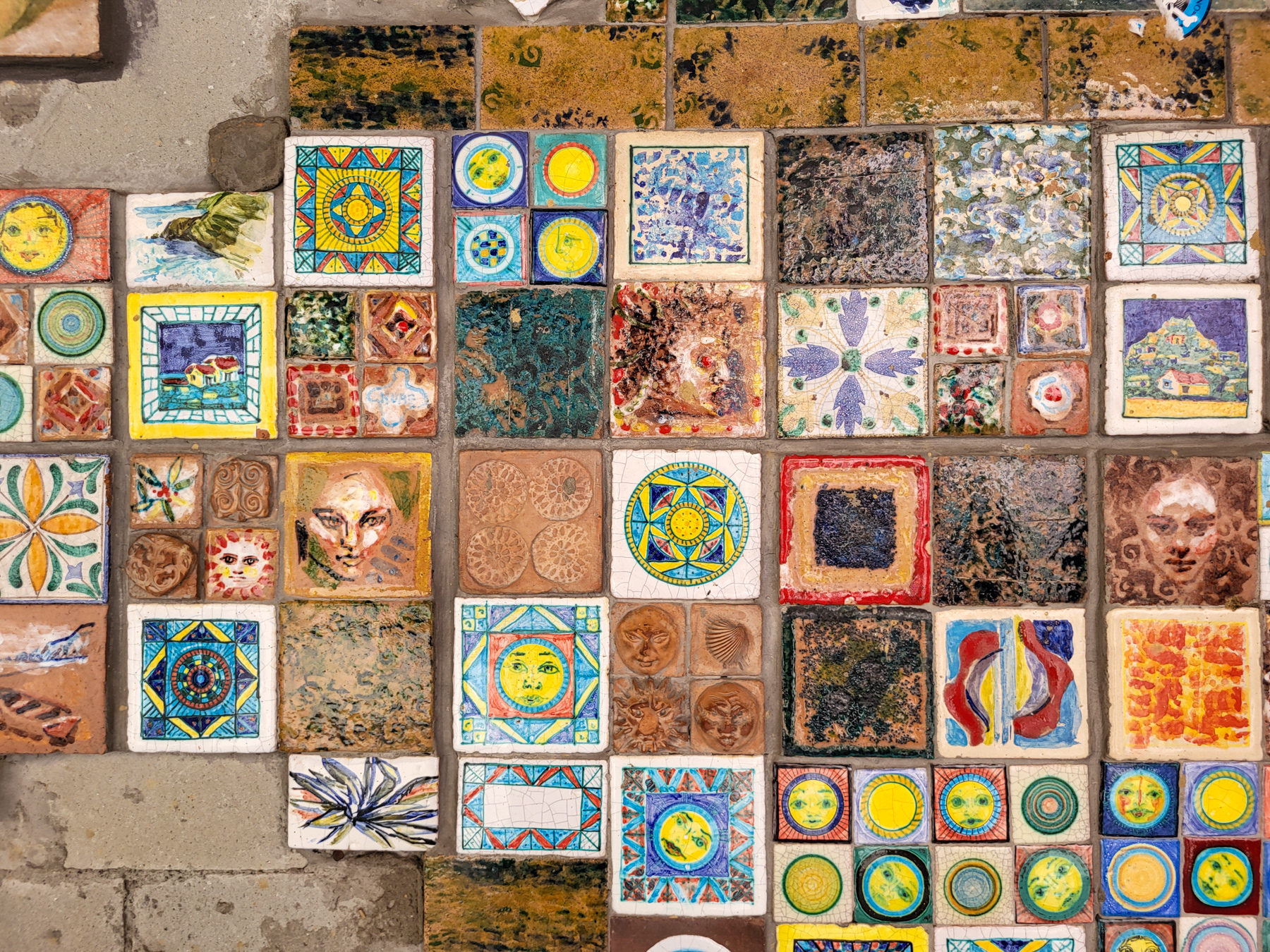 A wall of colourful tiles marks the border of the lower village and the higher village of Riomaggiore.