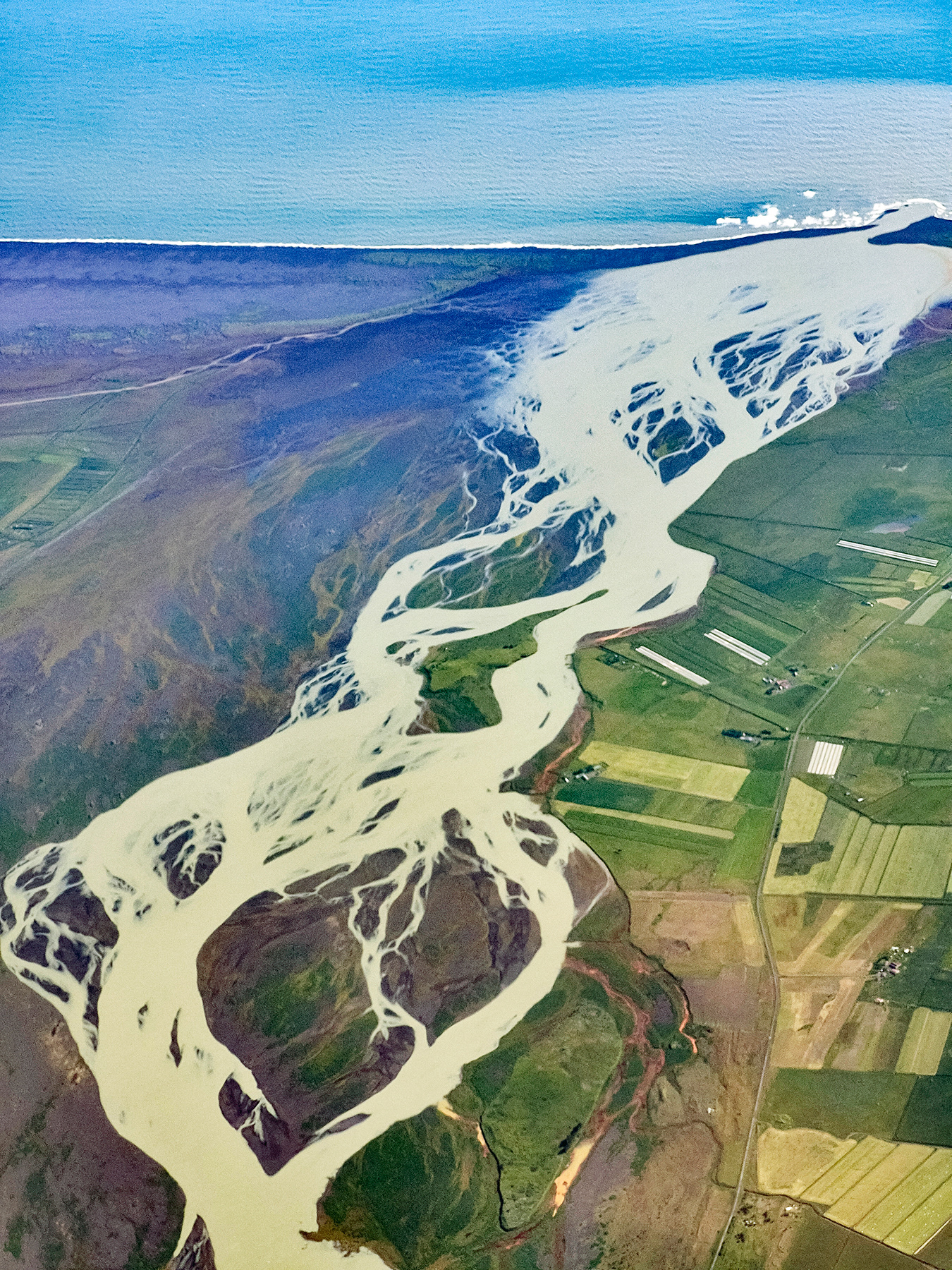 The Þjórsá River, with 240 km Iceland's longest, streaming into the Atlantic Ocean.
