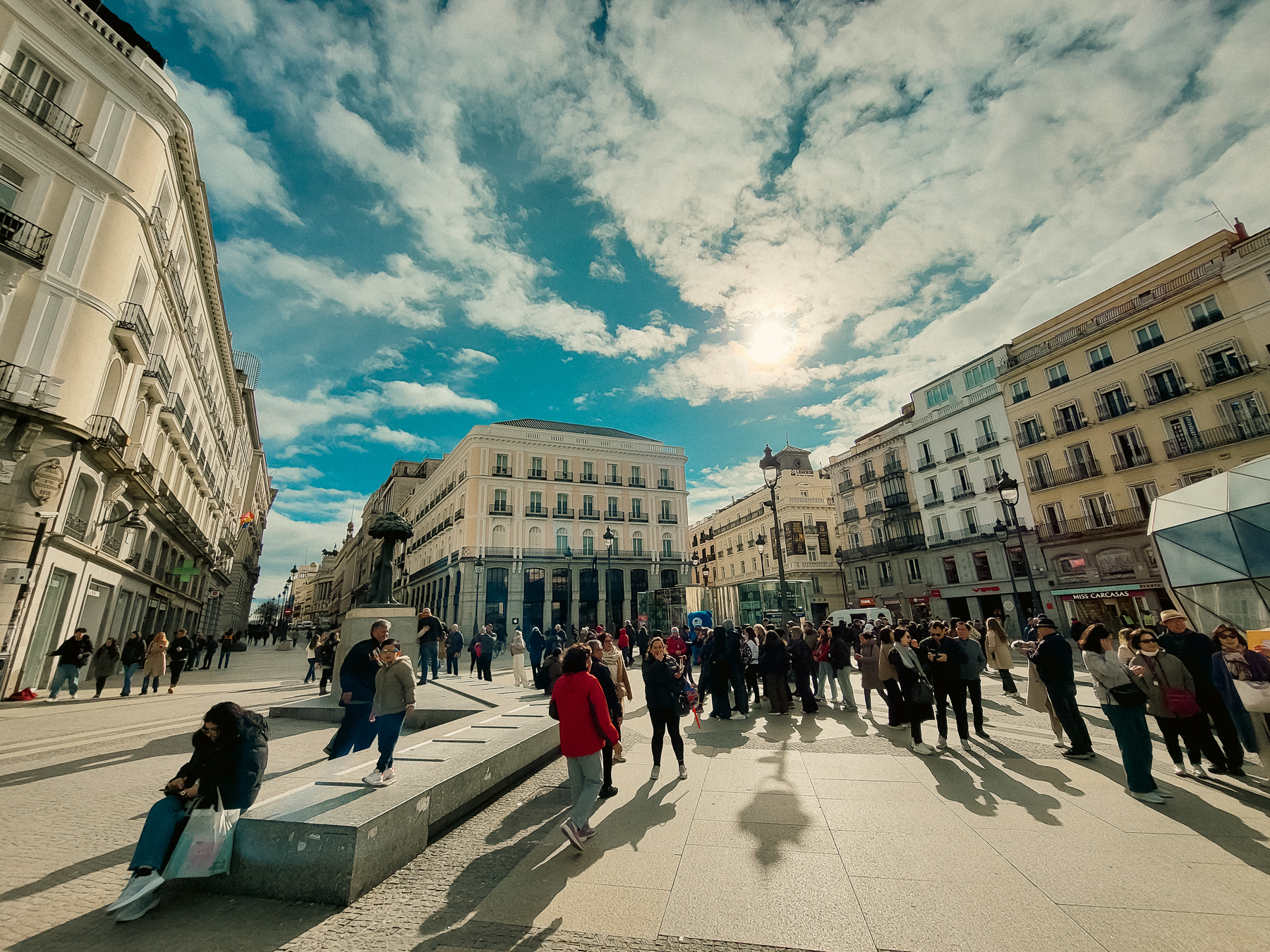 Puerta del Sol square facing the north. The statue of the bear and the tree on the left is one of the most photographed spots. Centre in the photo the former Hotel Paris, which used to have the Tio Pepe sign.