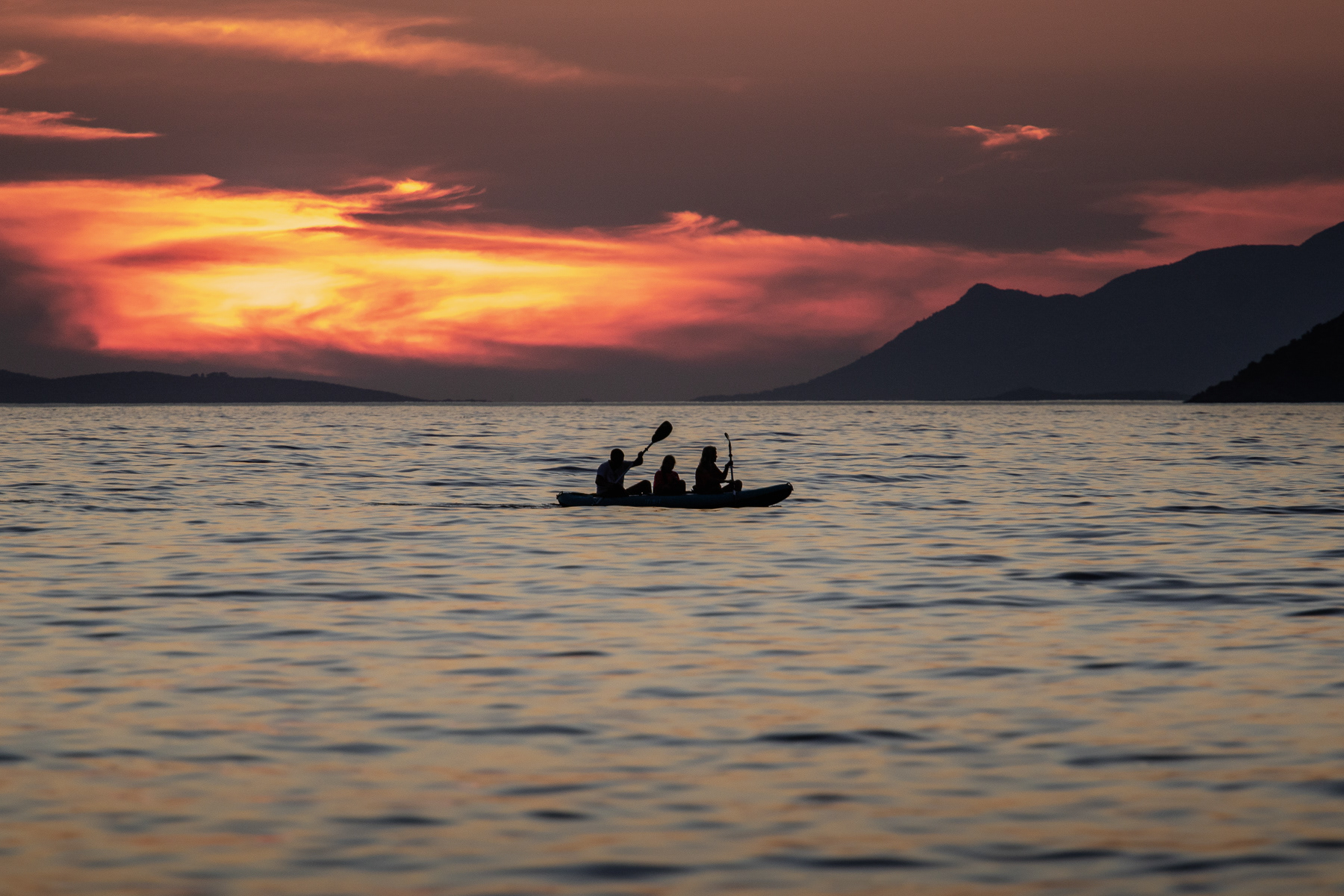 A family of three paddles to the sunset, Pelješac peninsula, August 2025.