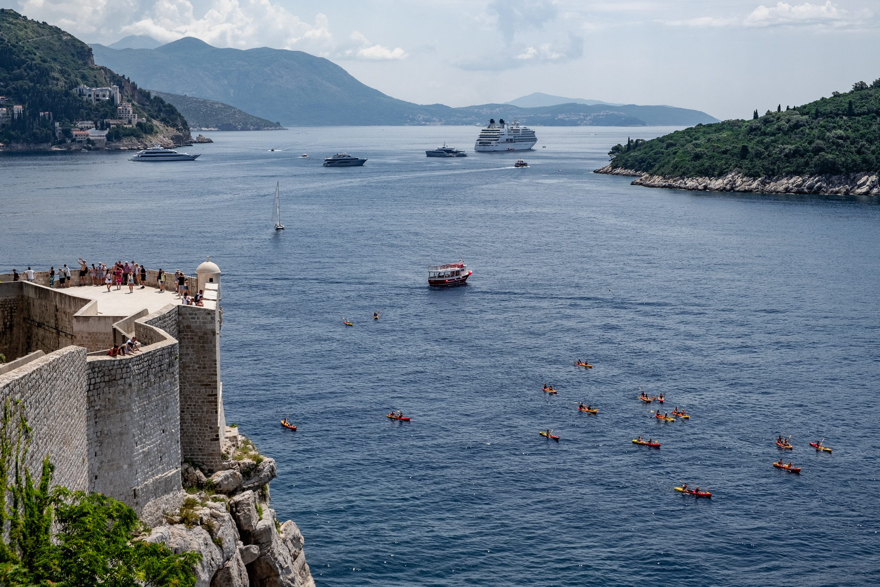 Kayakists and cruise ships just outside the fortified old town of Dubrovnik, July 2023.