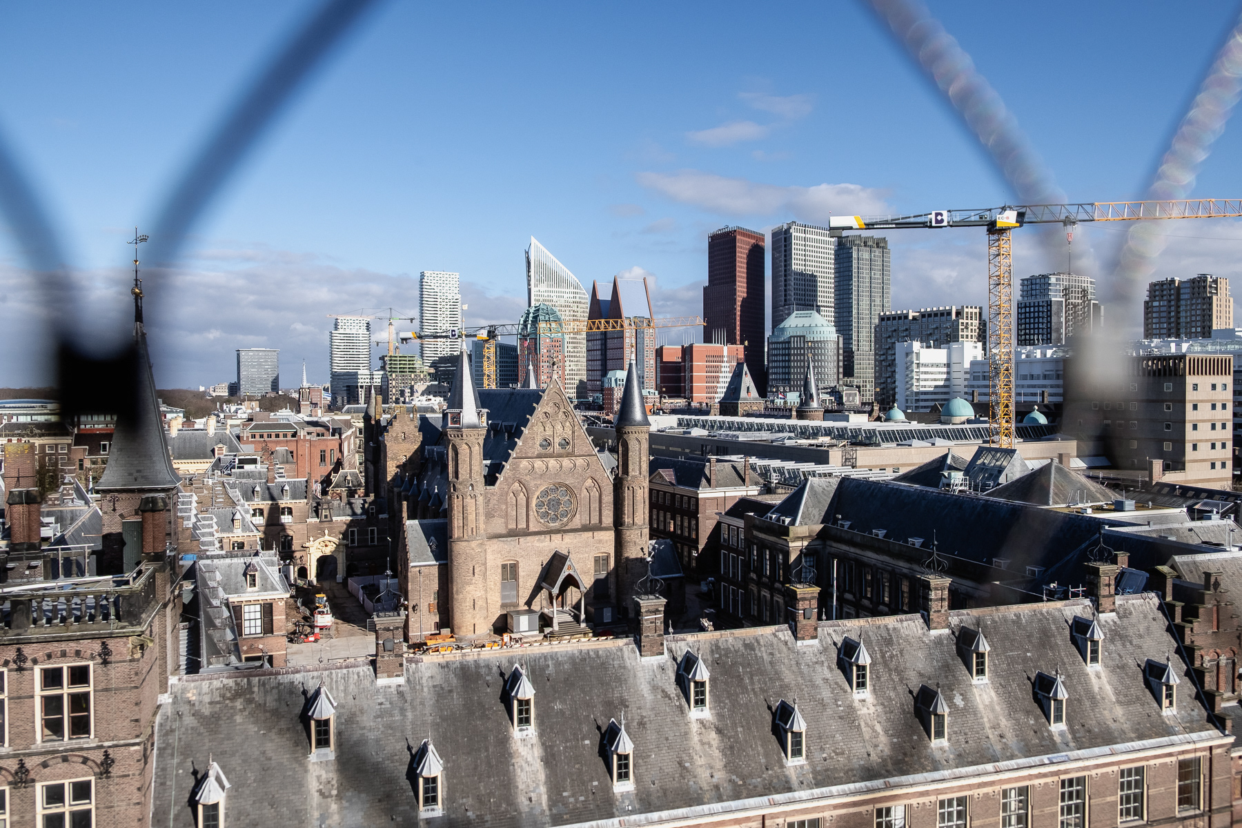 View of the modern skyline of The Hague, with the Binnenhof parliament buildings in the forefront of the photo.