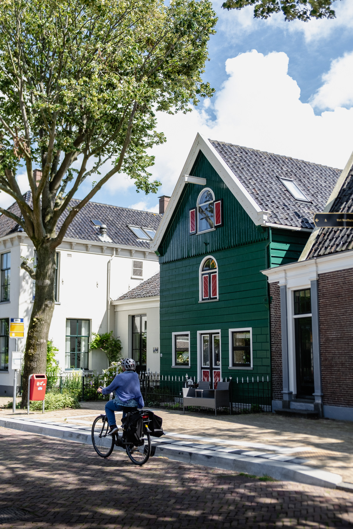 A cyclist passes a bus stop, Zaandijk, August 2023.
