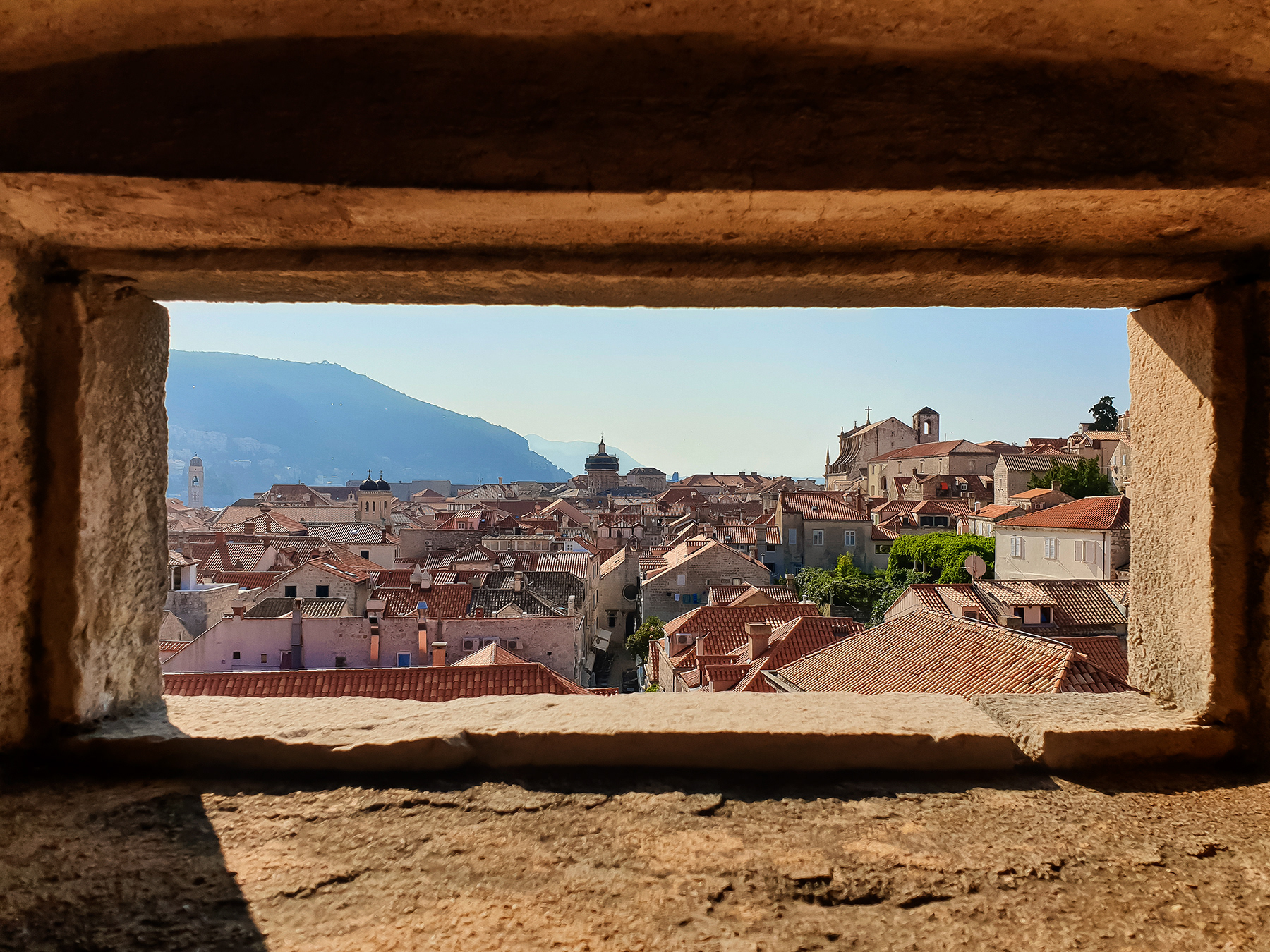 View at the old town of Dubrovnik through one of the defence walls strongpoints, July 2019.