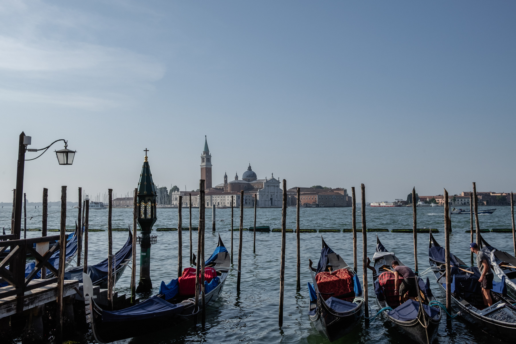 View at the San Giorgio Maggiore island, past by rows of gondolas, July 2023.