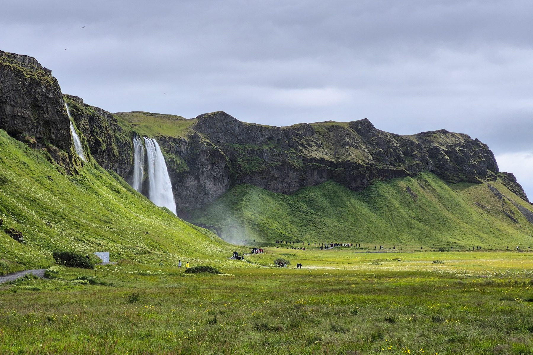 Seljalandsfoss waterfall seen from a little further away, with a second smaller waterfall on the further left of the photo.