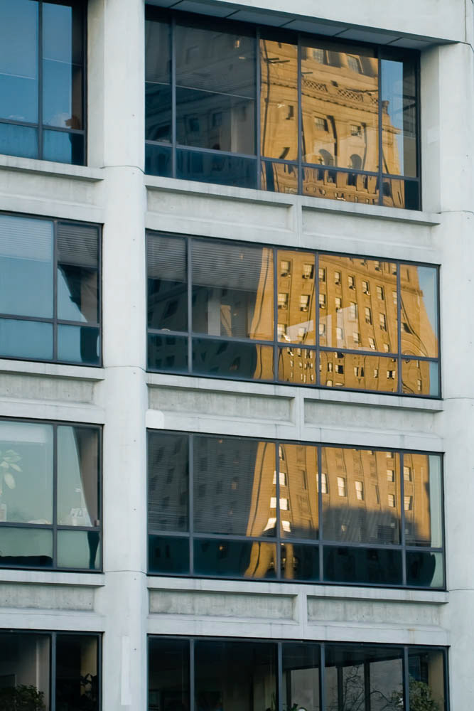 Reflexion of an old tower in a modern building.