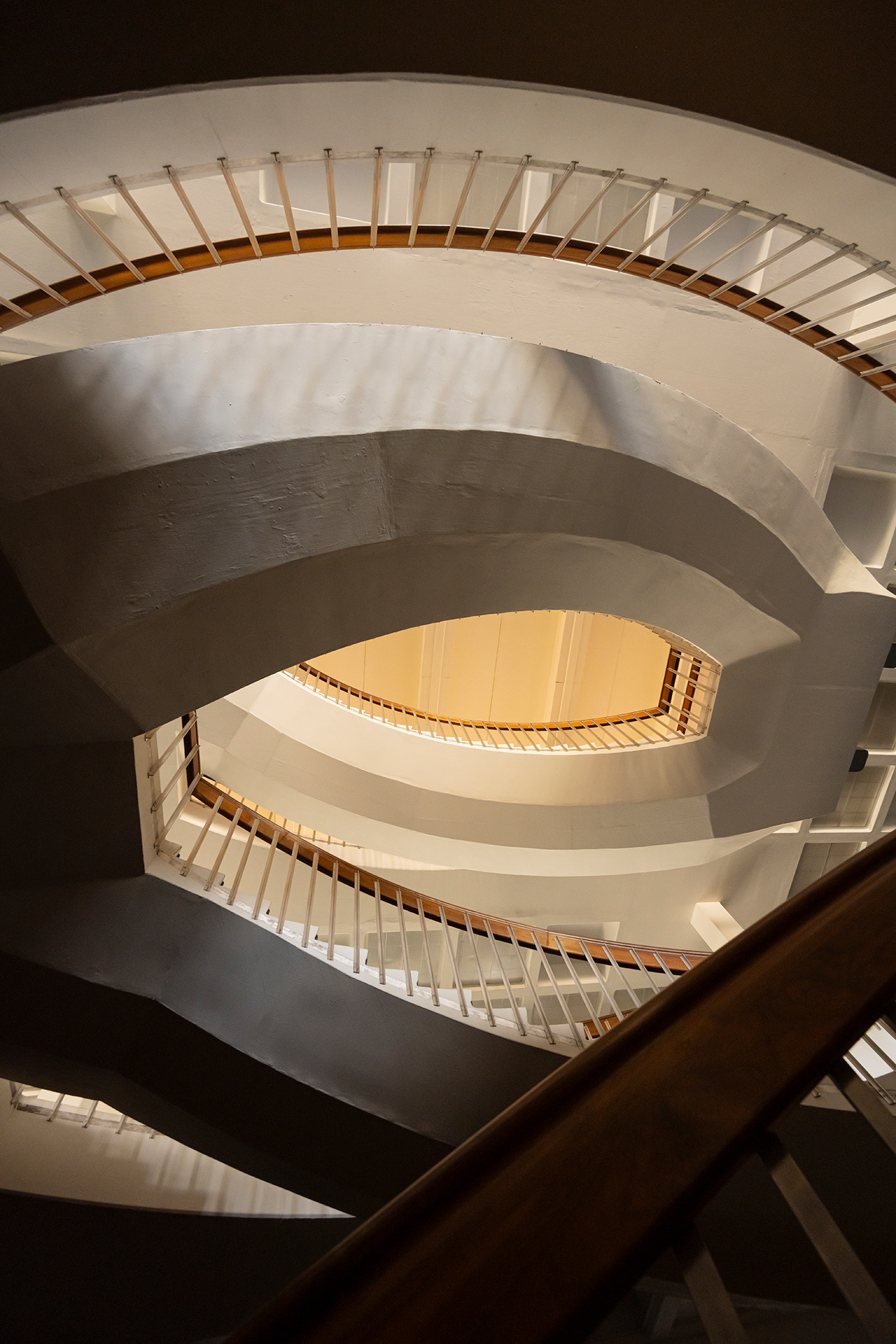 A wide angle view through the three floors of the Fogelson Library spiral staircase.