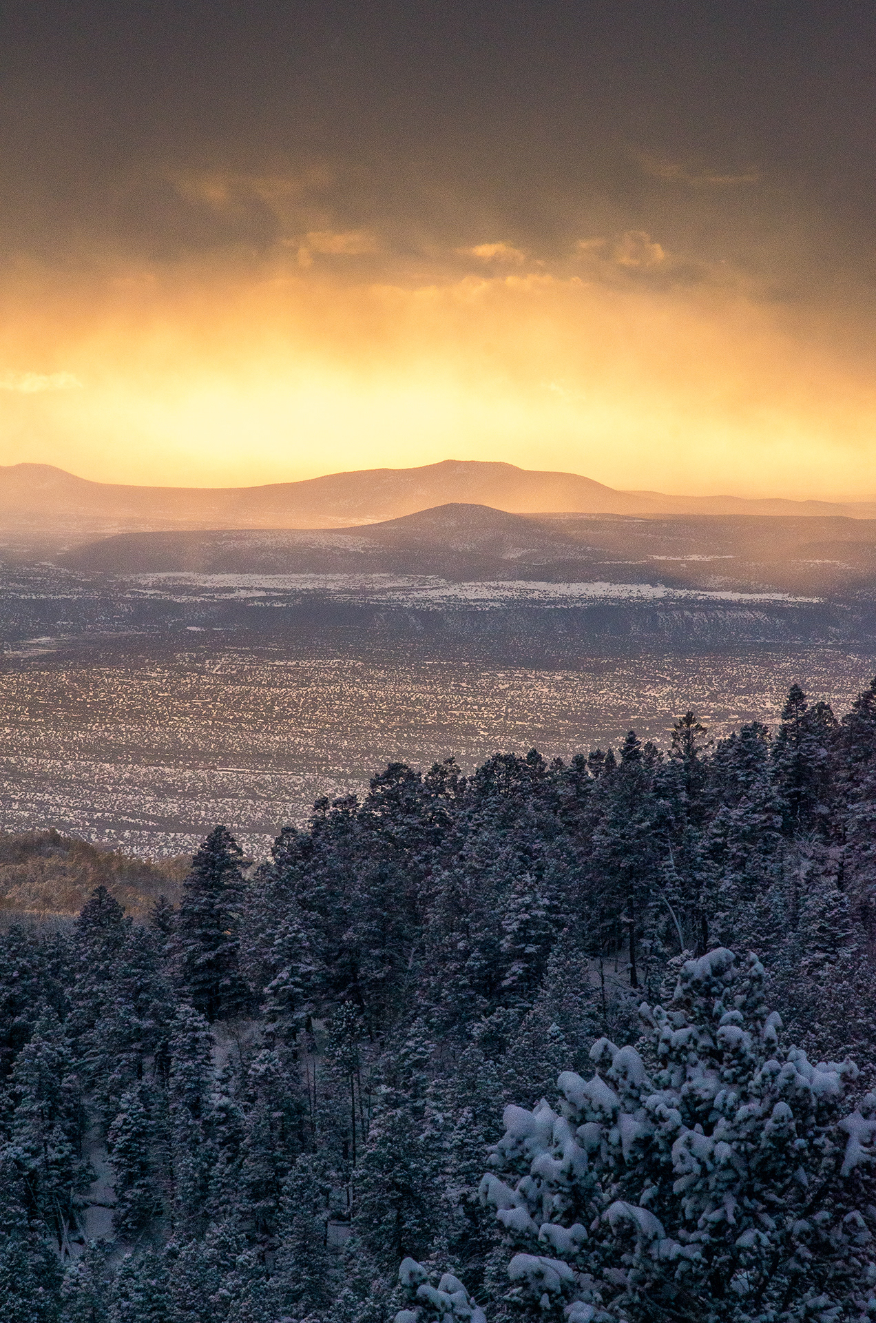 Looking out from the Vista Grande Overlook Observation Site as the clouds burn brilliant orange-yellow in the last moments before sunset