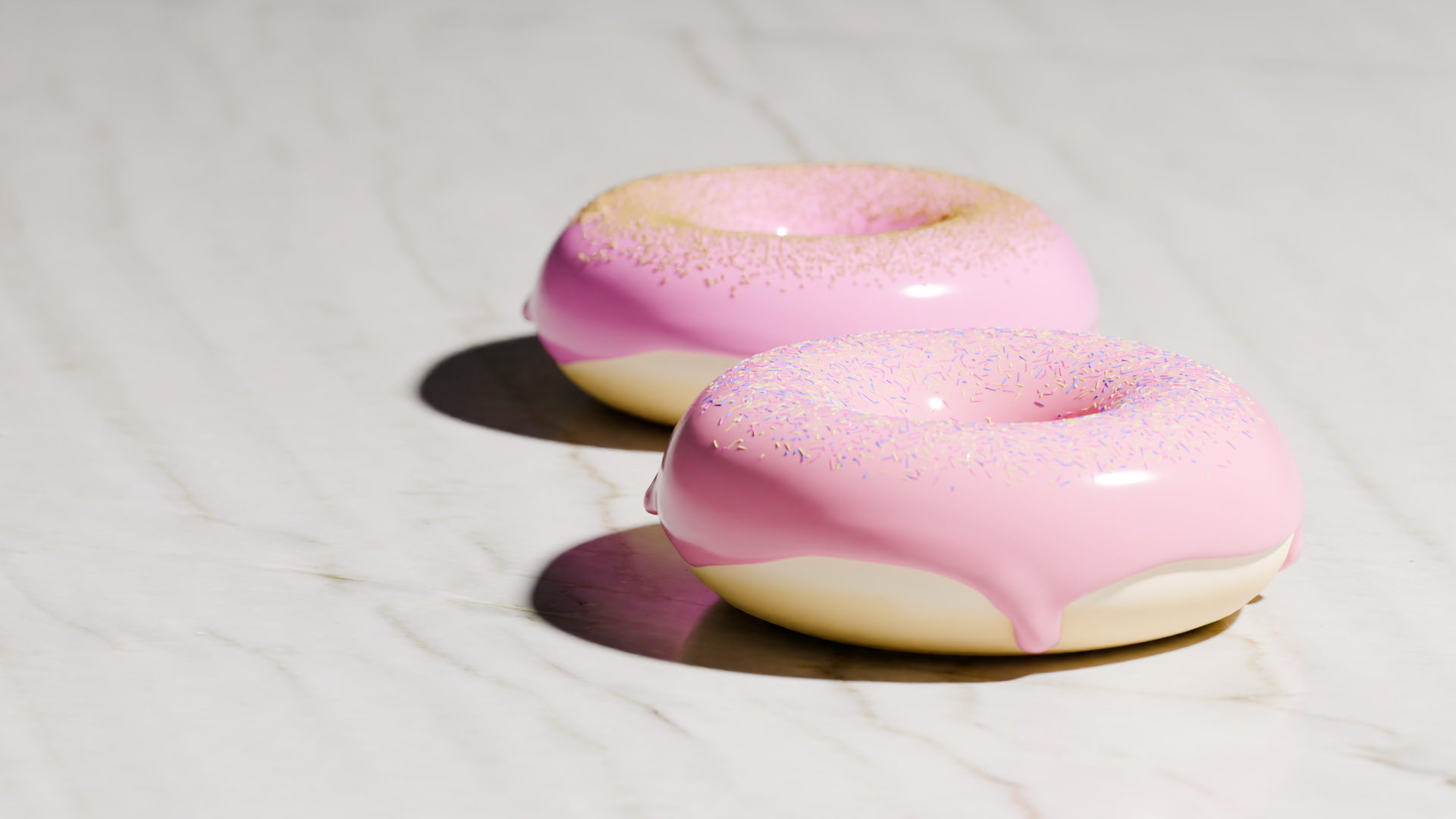 Donut Challenge: Blender donut tutorial, two pink iced donuts one sprinkled with gold sugar pearls and the other with small multicolored sprinkles