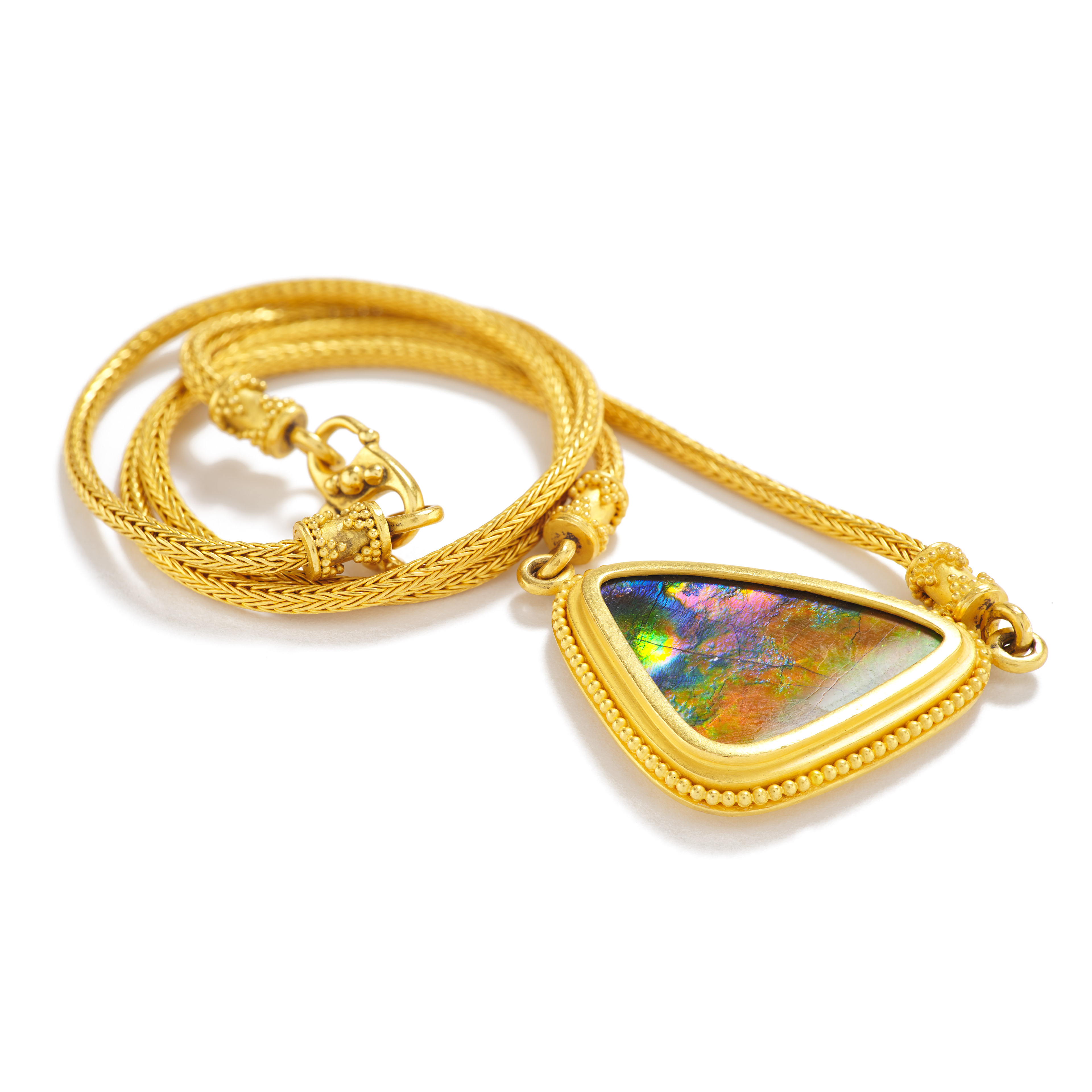 a rounded trillion cut ammolite necklace hand crafted by Balinese goldsmiths in collaboration with Carolyn Tyler