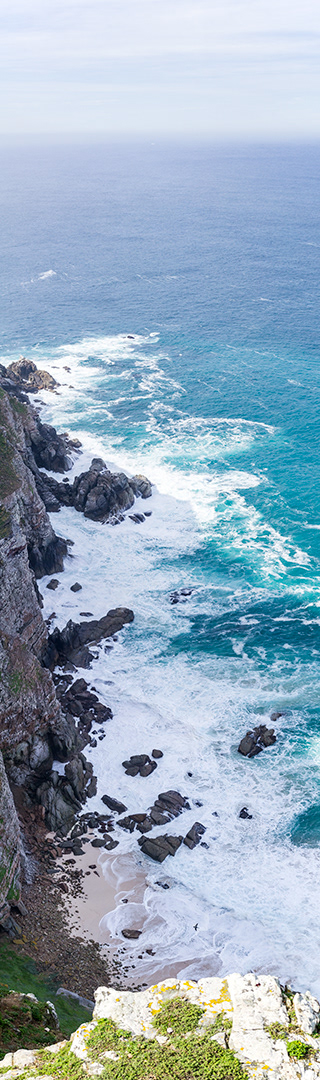 looking 300 feet below at the frothed waters of the South Atlantic as the smash amongst the black boulders of Cape Point