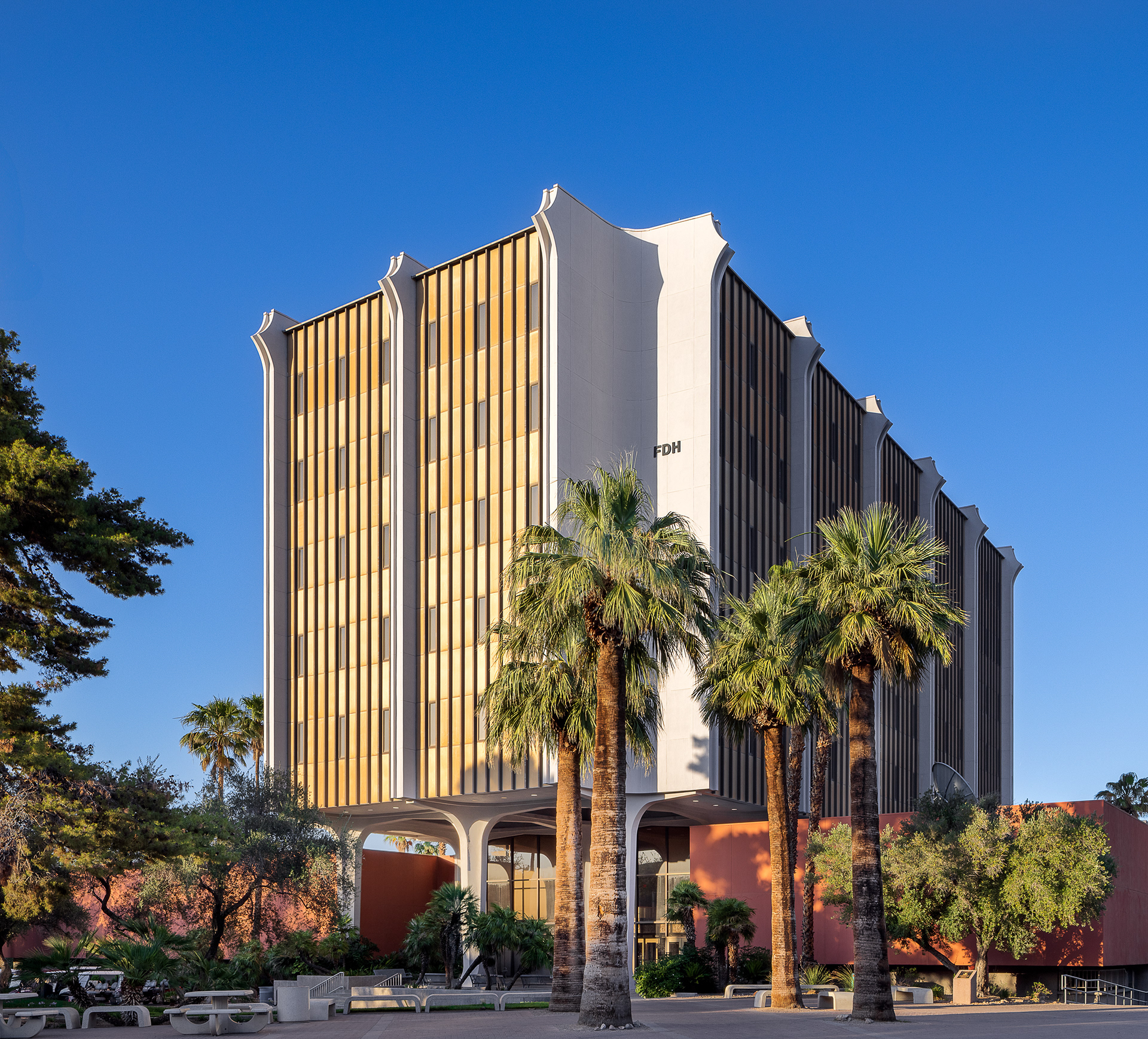 Flora Dungan Humanities Building at the University of Nevada Las Vegas with palm trees and mid century modern architecture.