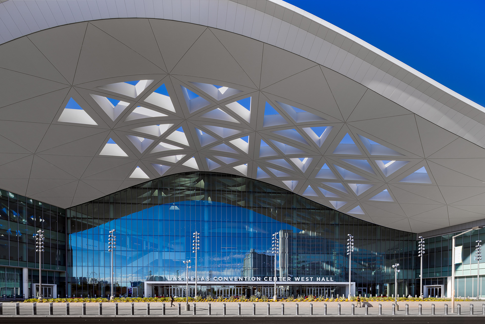 West Hall main facade and signature geometric roof canopy.