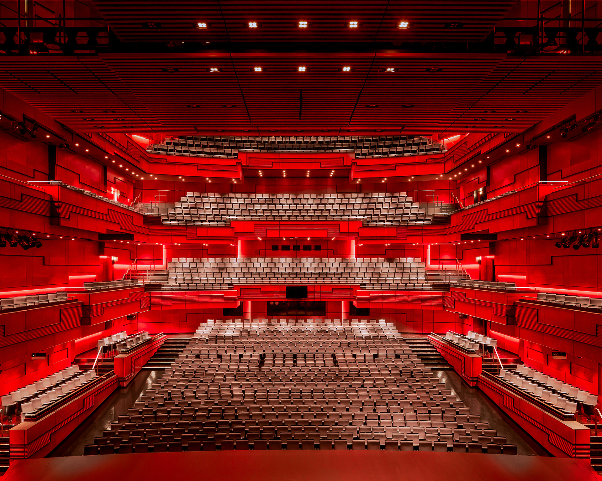 Interior of Eldborg Hall at Harpa Concert Hall in Reykjavik Iceland featuring red acoustic architecture and tiered seating