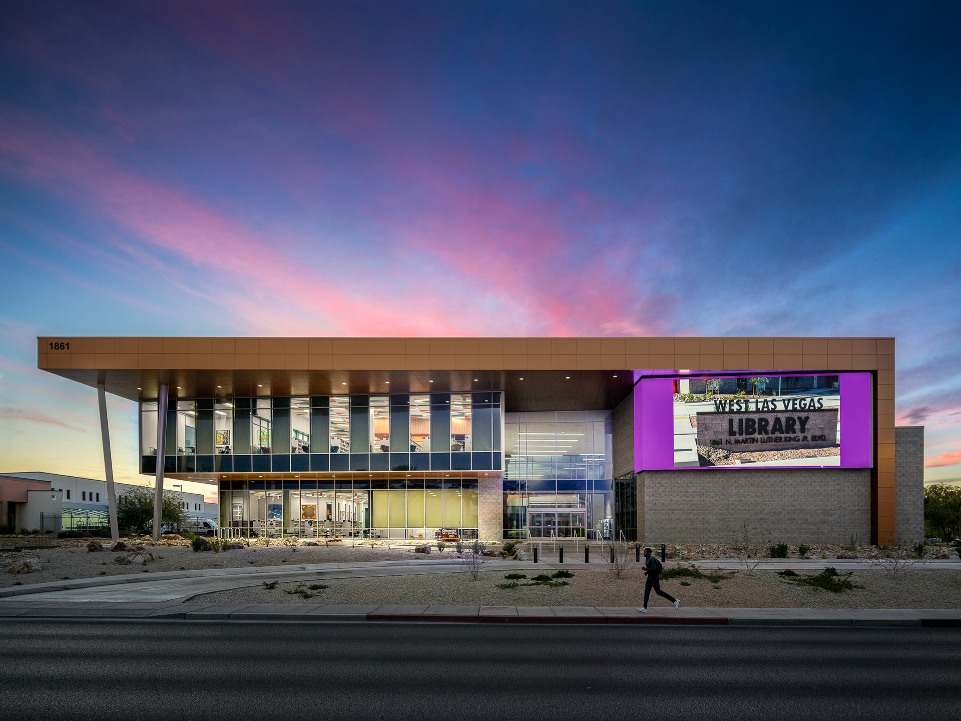 West Las Vegas Library exterior at twilight, showcasing architectural lighting and modern civic design. Architecture by KME Architects with Moody Nolan, and landscape design by LAGE Design.