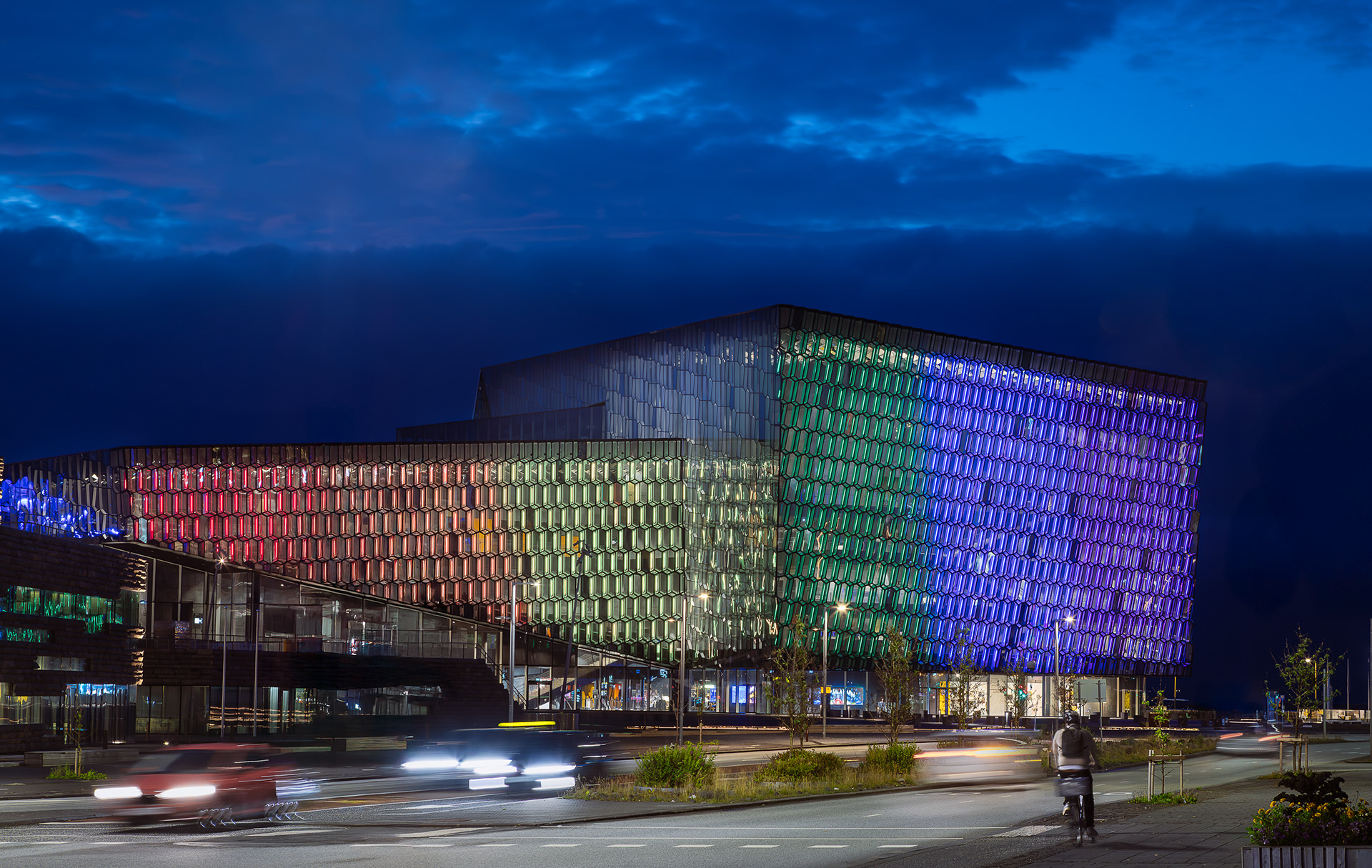 Harpa Concert Hall exterior at night in Reykjavik Iceland with illuminated geometric glass facade and colorful LED lighting