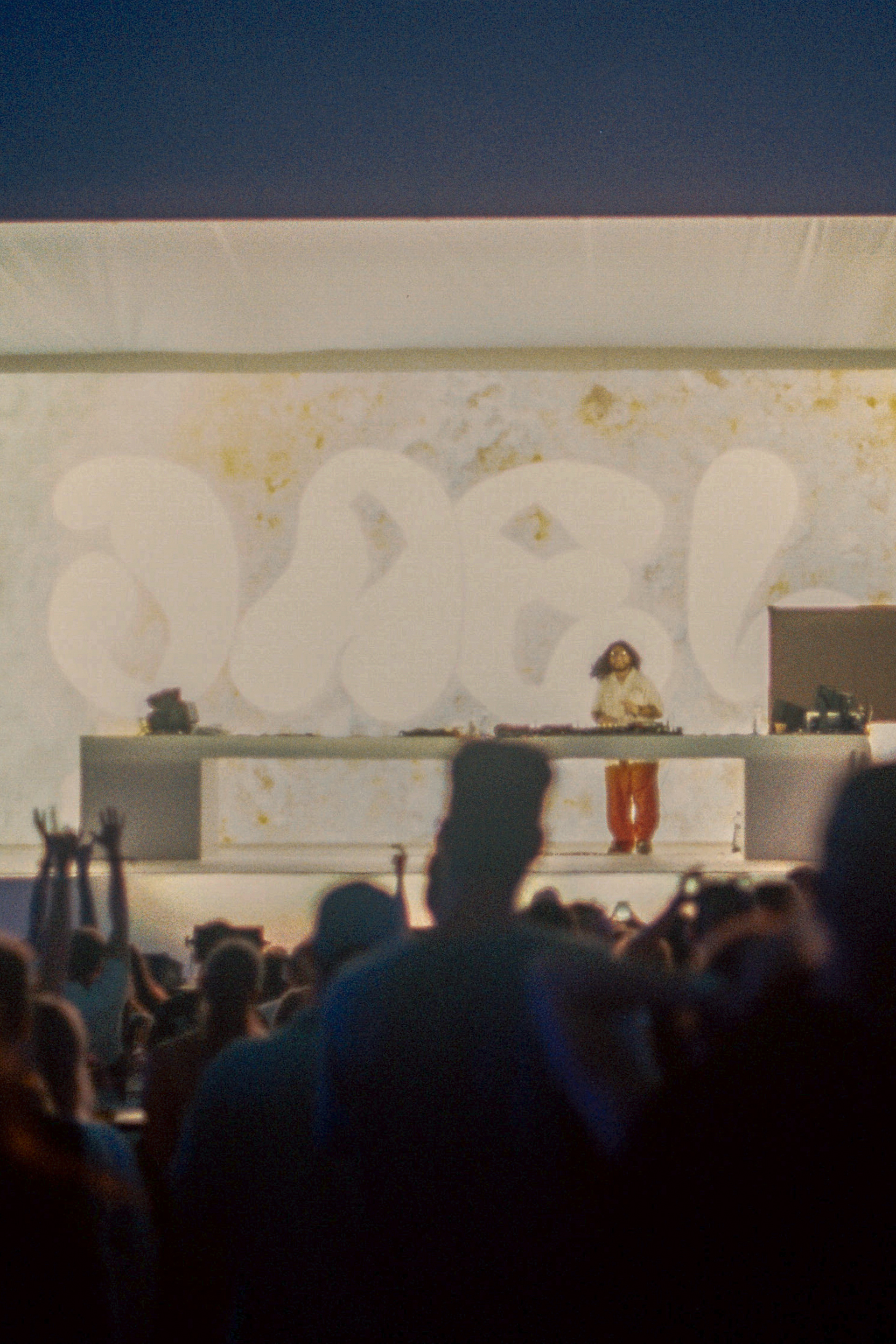 Warm-toned analog snapshot of outdoor stage and crowd at Zeny Vino Funk festival, summer vibe / Teplý analógový záber na vonkajšie pódium a dav na festivale Ženy Víno Funk, letná atmosféra.