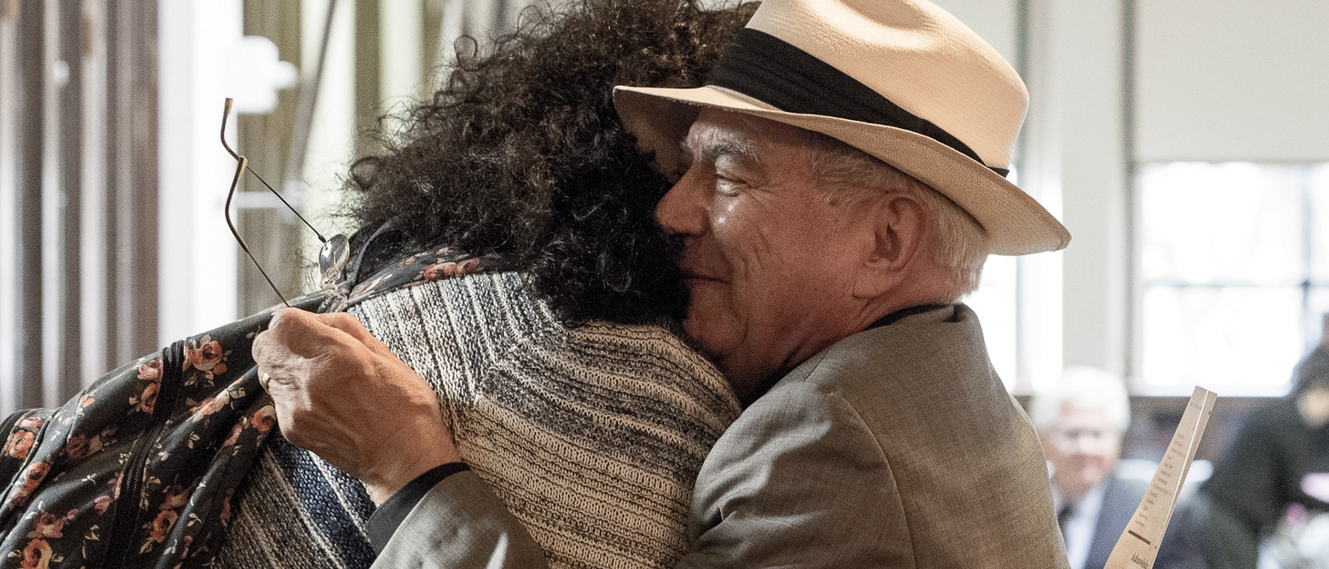 April 2016 - Student gives Dr. Arturo Madrid a farewell hug at his retirement party.