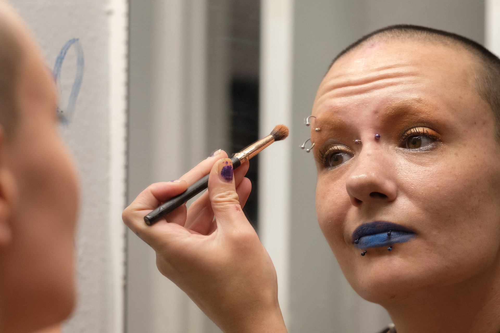 Io Panizzon applies eyeshadow in a decorated mirror Nov. 22, 2024, at home in Wheat Ridge. The name Io comes from the name of one of Jupiter’s moons, Io, as well as the figure from Greek mythology. (Claudia A. Garcia, Special to The Colorado Sun)