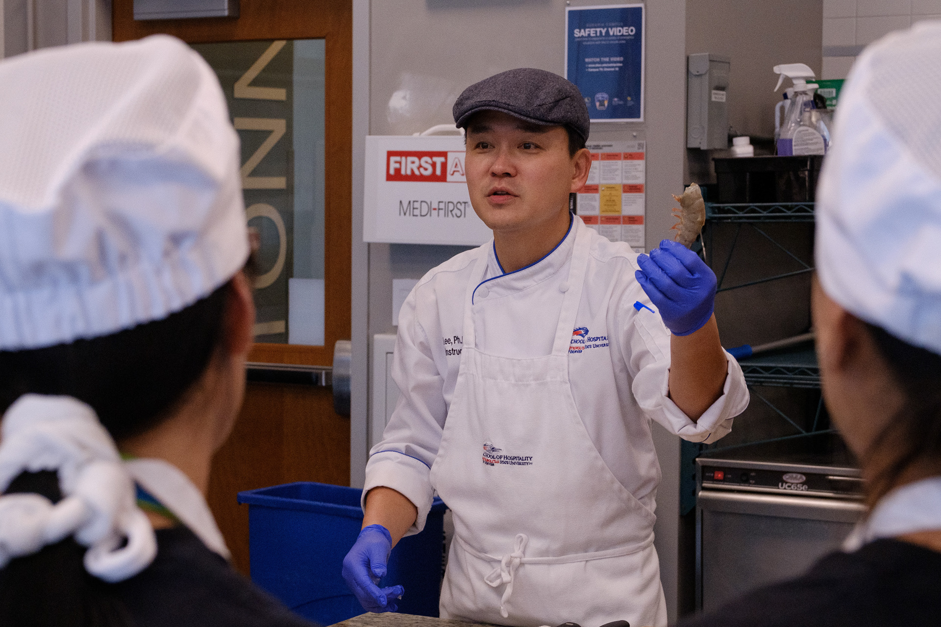 Dr. Chef Jay Lee teaches students how to peel and devein shrimp at the MSU Hospitality Learning Center on the Auraria Campus. He also demonstrated advanced shrimp preparation techniques, such as shaping the raw shrimp into hearts. (Claudia A. Garcia, Special to The Colorado Sun)