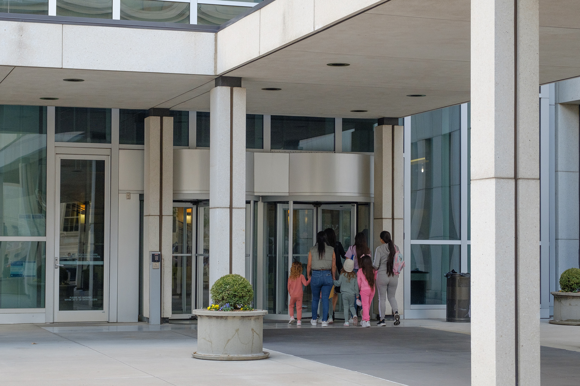 A family approaches the doors Thursday, Oct. 24, 2024, at the Byron Rogers Federal Building in the downtown Denver Federal District. The building houses eleven federal agencies, including the Denver Immigration Court. (Claudia A. Garcia, Special to The Colorado Sun)