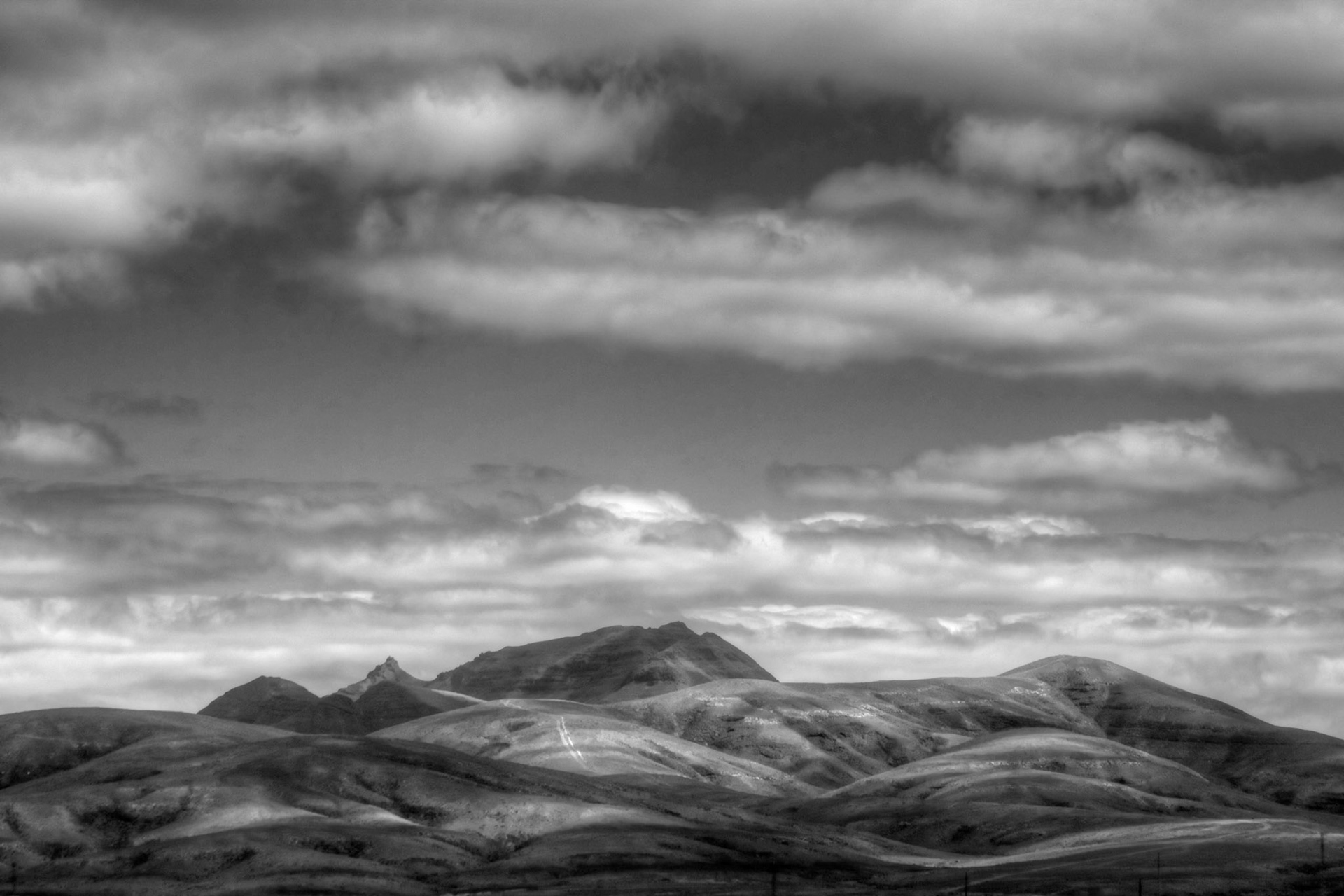 Rounded hills with the shadows of the clouds above gives a wonderful images, especially in black and wihite