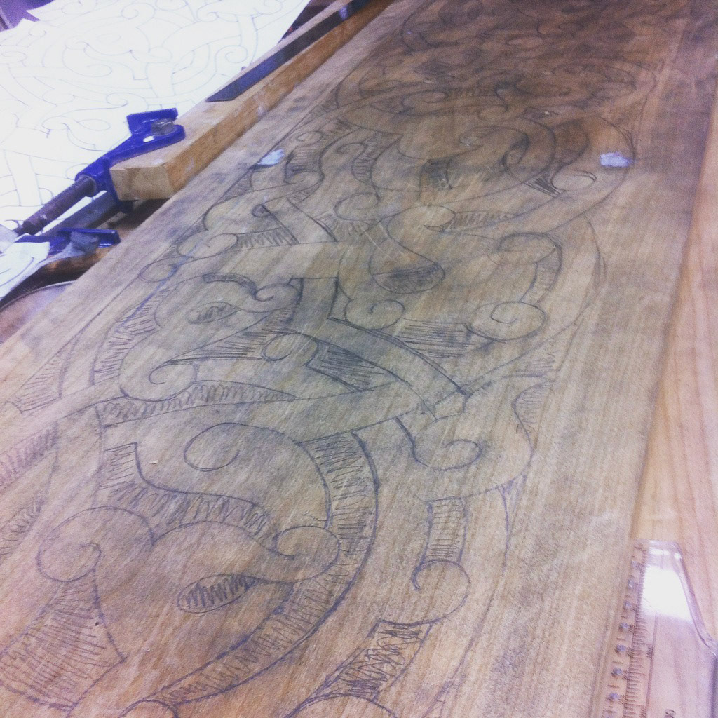 Drawing the biomorphic dragon shapes onto the planks