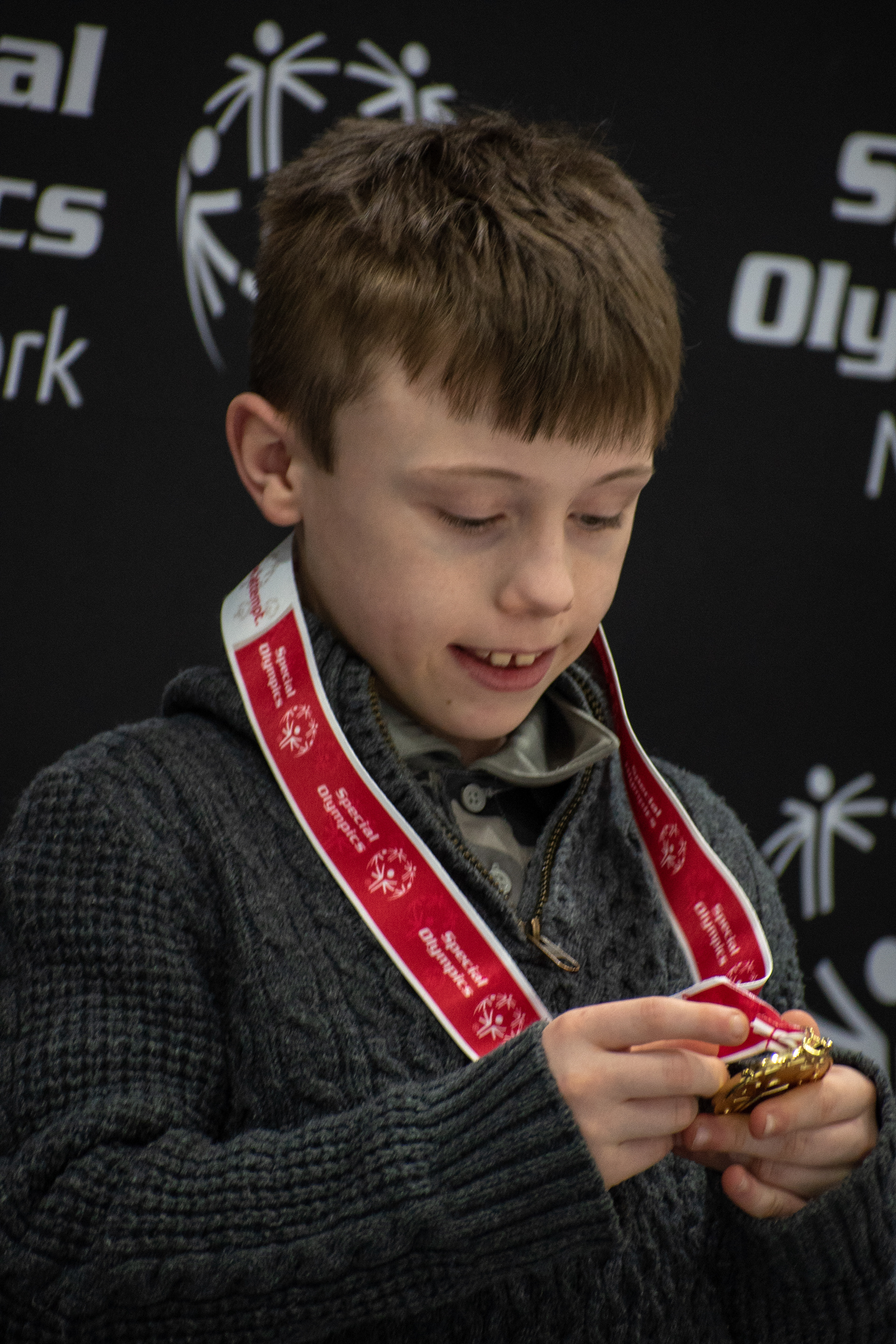 Aaden Jones looks at his gold medal at Special Olympics New York, on February 24th, 2019,  at the Genesee Valley Sports Complex in Rochester New York.