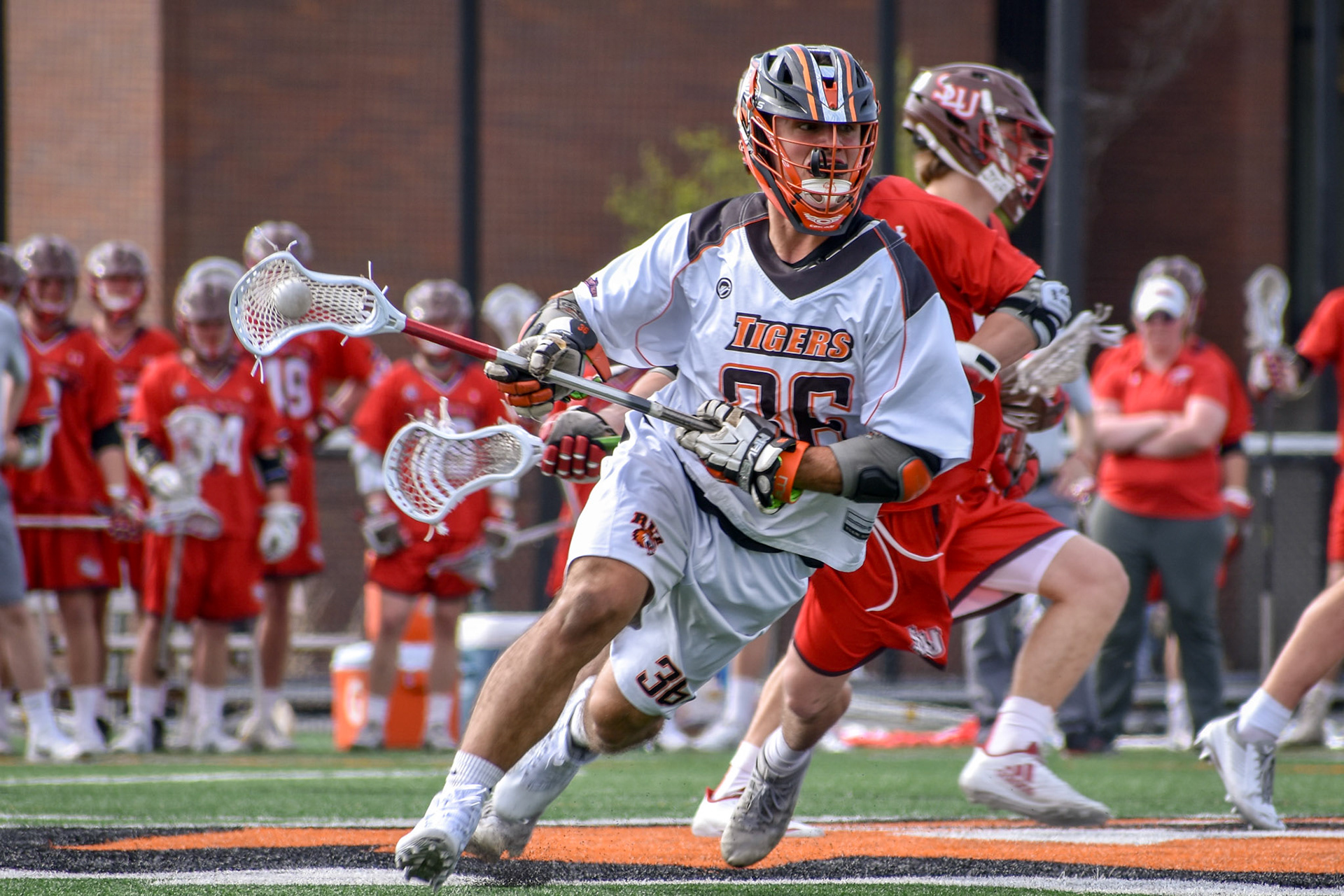 Nate Farrell(#36) of RIT enters into St Lawrence's offensive zone, during Liberty League semi final game with RIT vs St Lawrence on May 2nd 2018 at the RIT Turf in Henrietta NY. . RIT Won 13-10 .