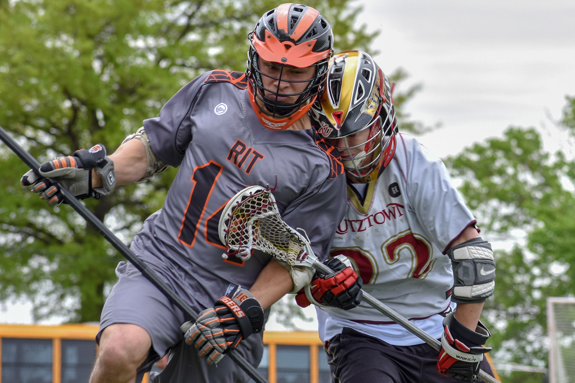 RIT Longpole, Chris Ferri (#14), attempts to clear the ball from defensive zone during the first round of the elite 8 in NCLL tournament, on May 5th 2018 at the US Naval Academy, Annapolis Maryland. RIT Won 14-6. Marblehead Festival of the Arts Photojournalism Award